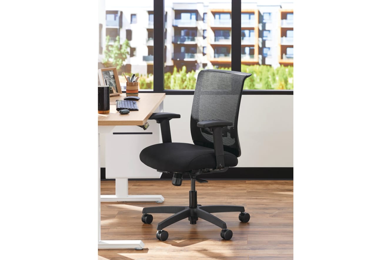 Two white Coordinate Height-Adjustable Bases paired with Coze desk tops and Convergence Task chairs in a small office setting