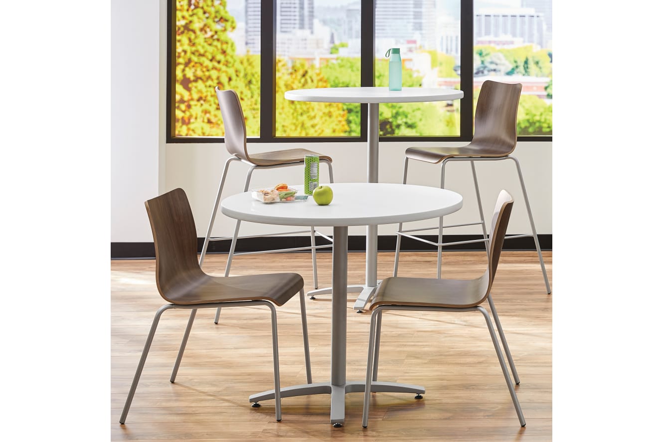 Between Standing and seated height tables with Ruck chairs in a café area