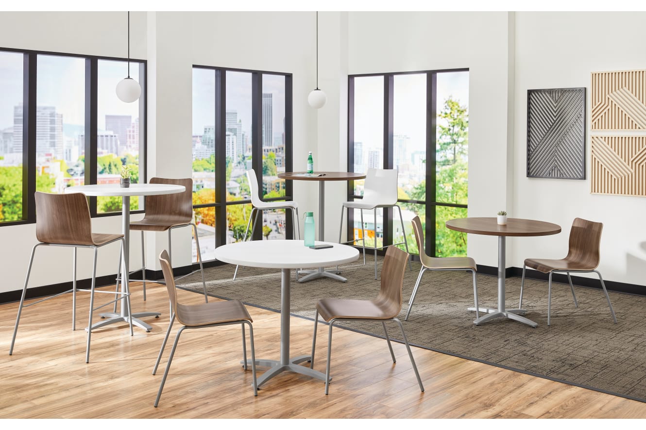 Between Standing and seated height tables with Ruck chairs in a café area
