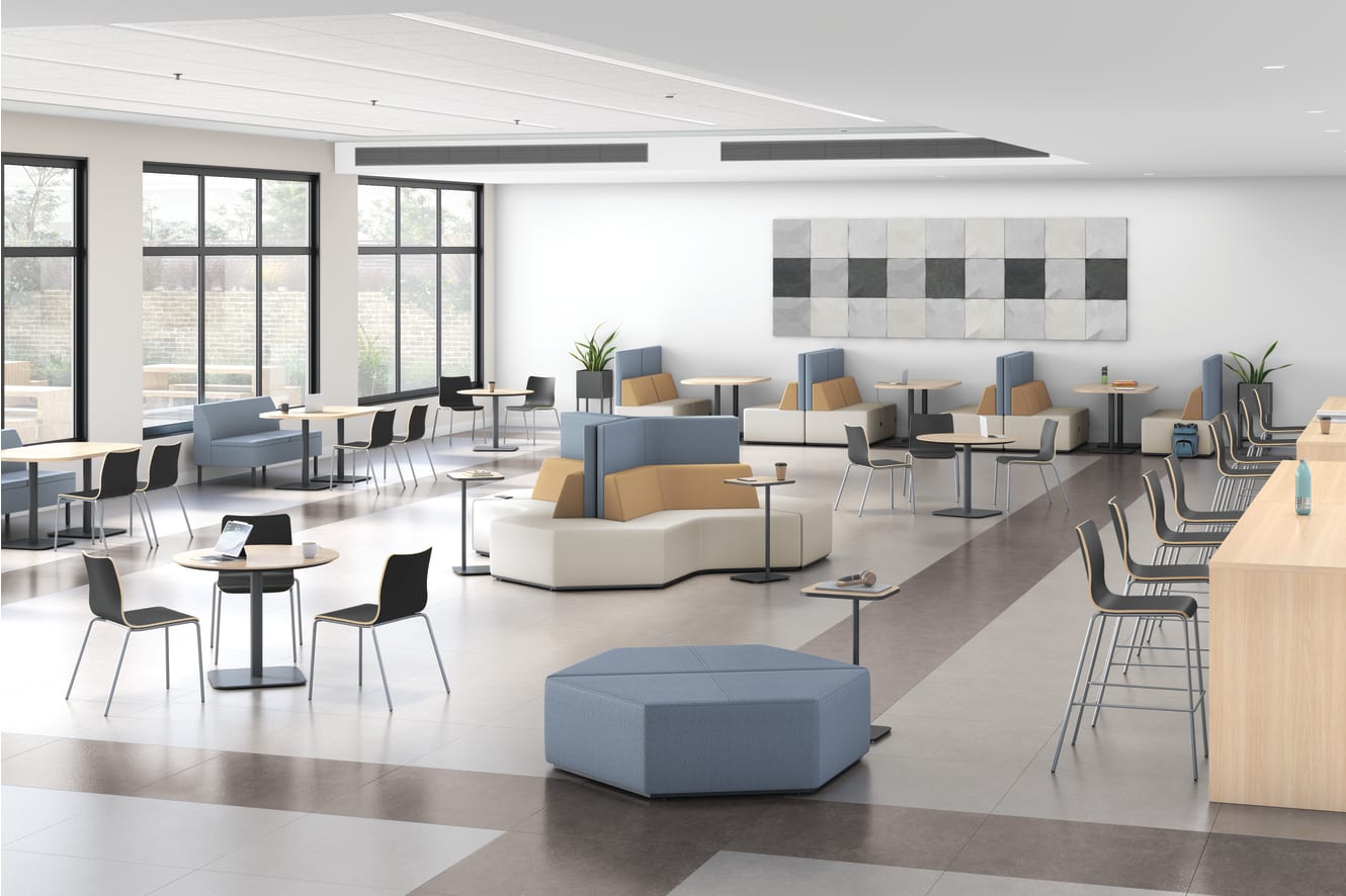 A modern and spacious office or lounge area with comfortable seating, tables, and a minimalist decor featuring neutral colors and geometric patterns on the walls.
