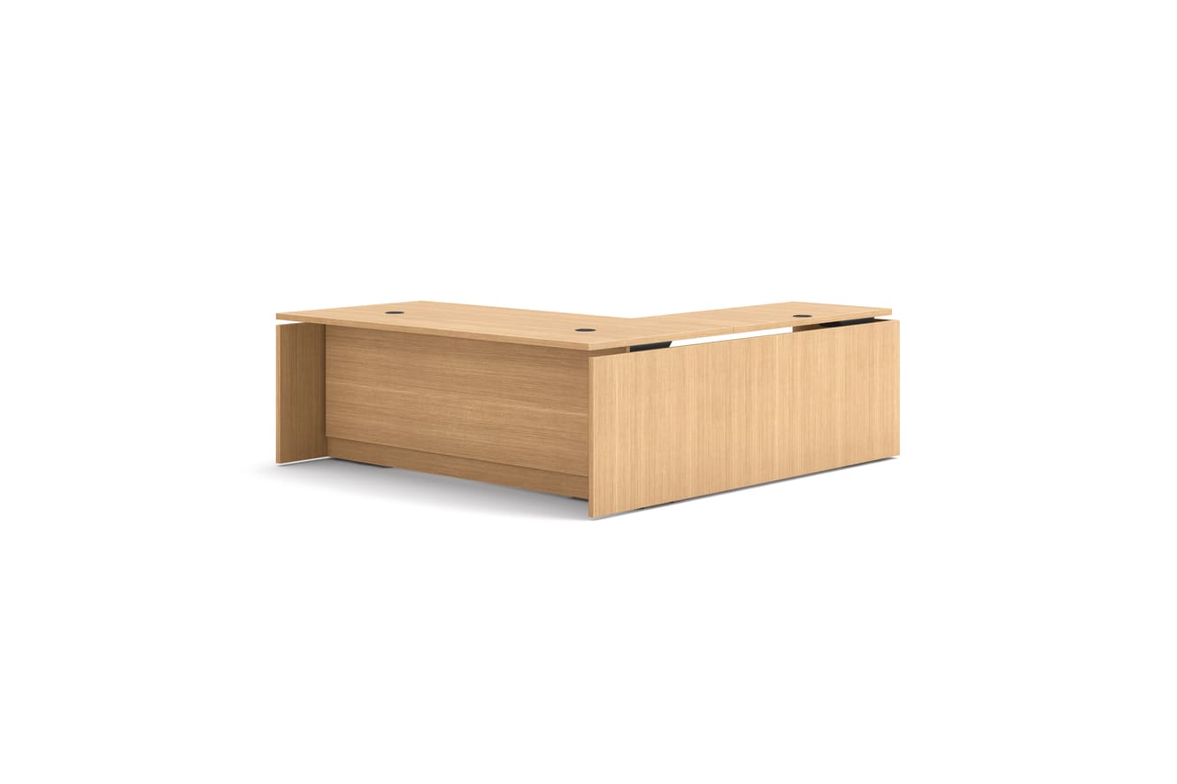 L-shaped executive workstation with woodgrain finish, integrated power access, and pedestal file storage.