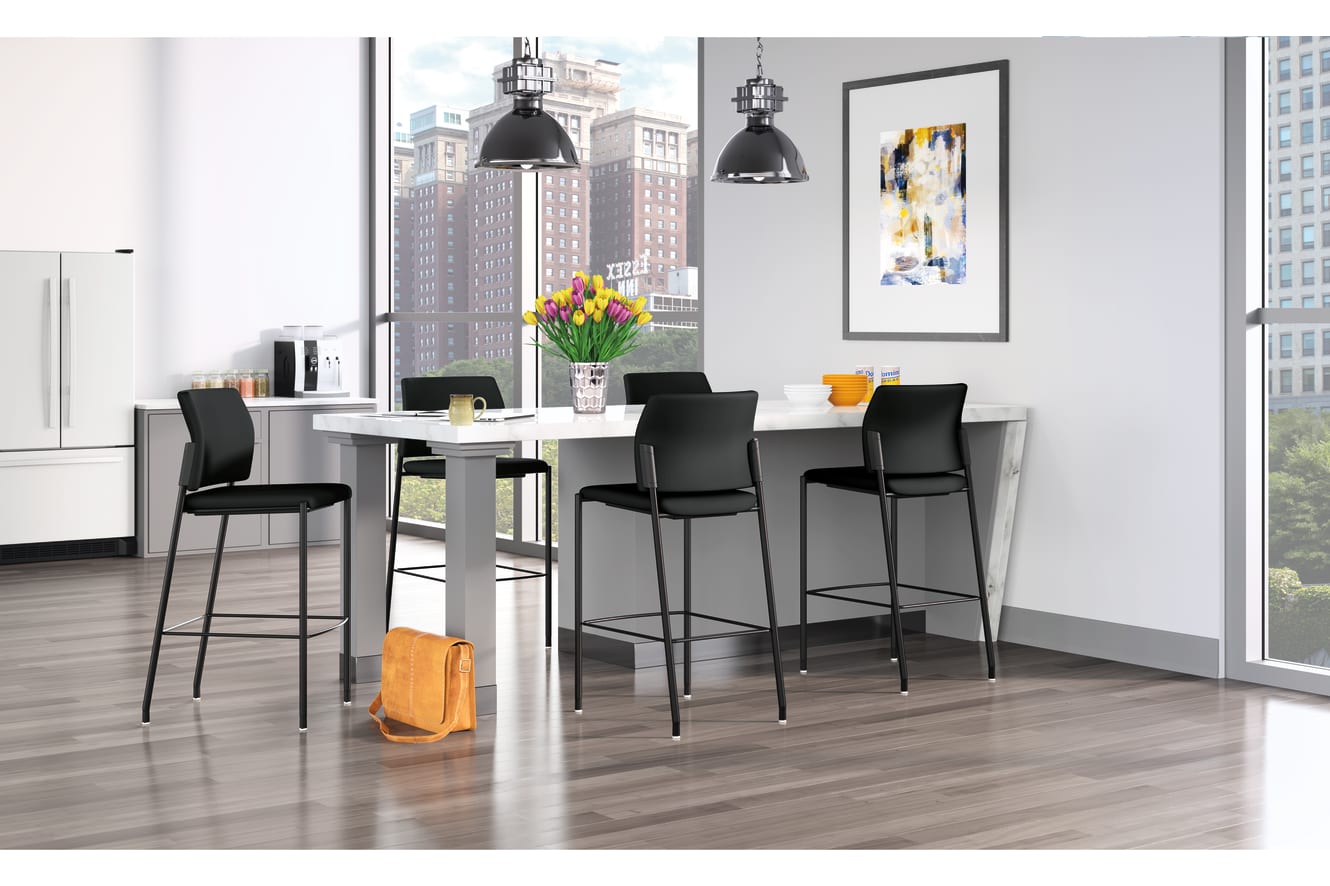 A modern and stylish dining area with a white table, black bar stools, and large windows overlooking a cityscape in the background. The room is decorated with a colorful abstract artwork and pendant lighting fixtures.