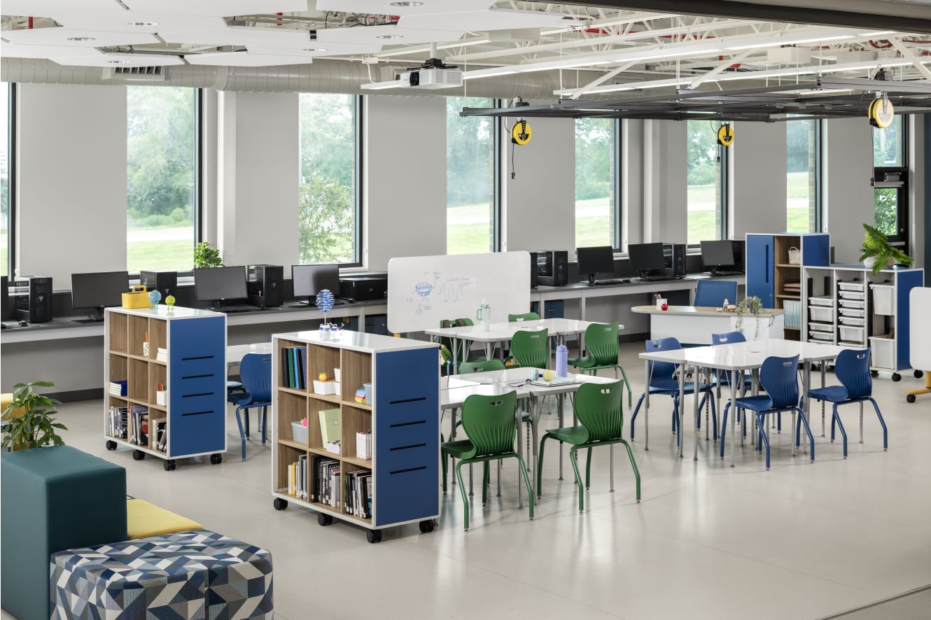 Makerspace classroom with blue and green chairs and storage solutions.