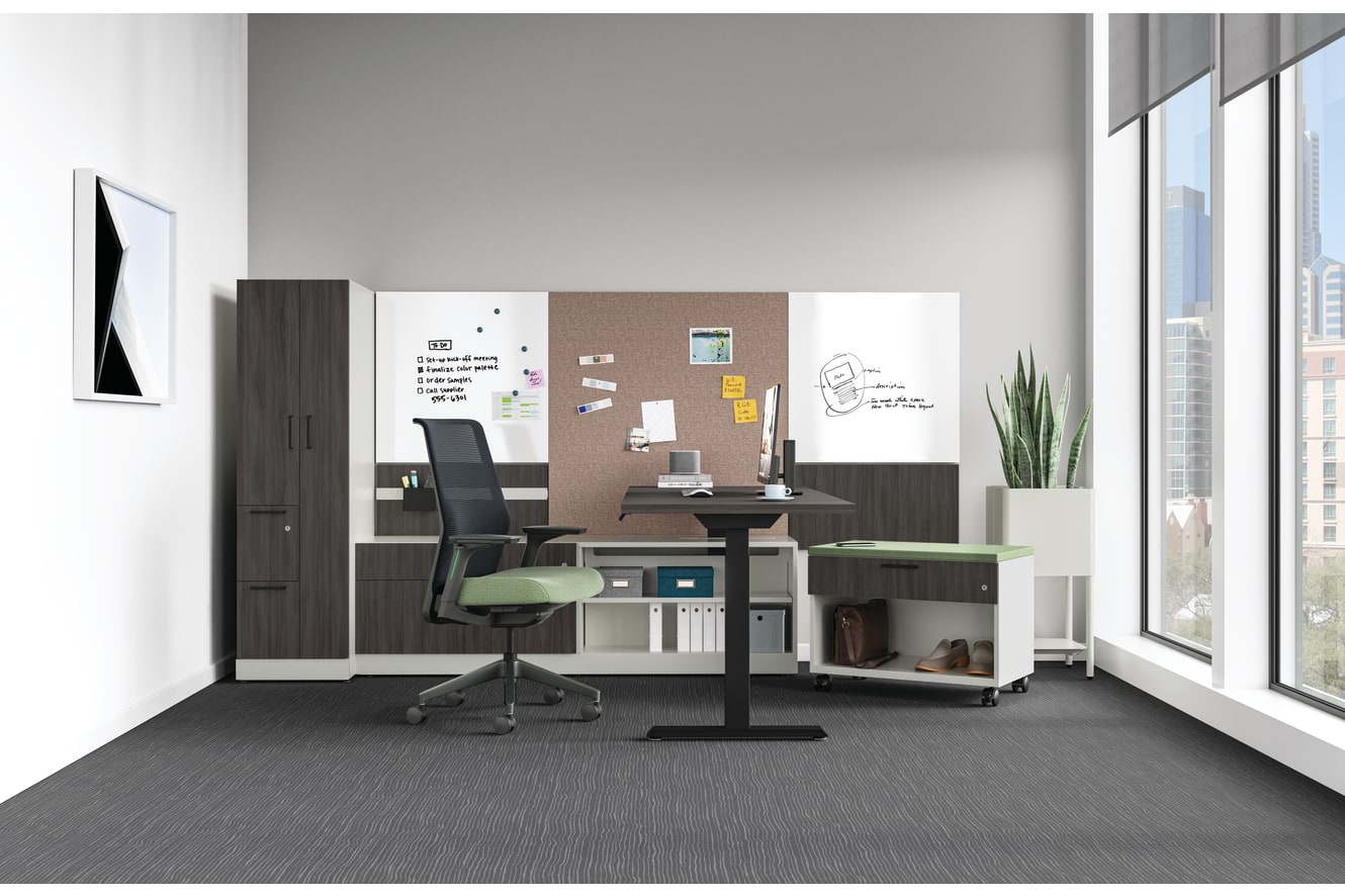 A modern, minimalist home office setup with a desk, chair, and various storage and organizational elements, set against a bright, airy backdrop with large windows.