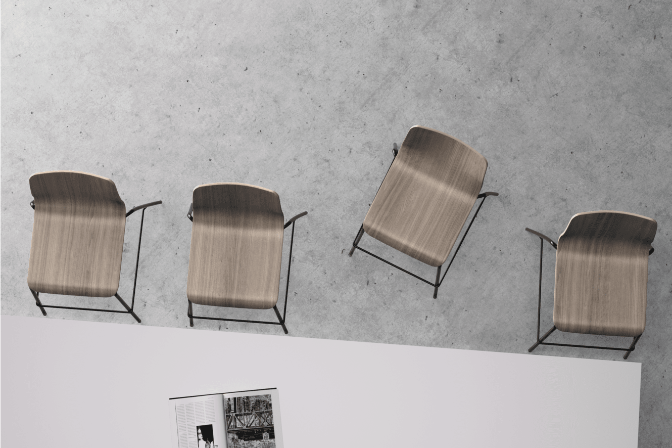 Four wooden chairs with curved backs and metal frames are arranged in a row against a plain white background.