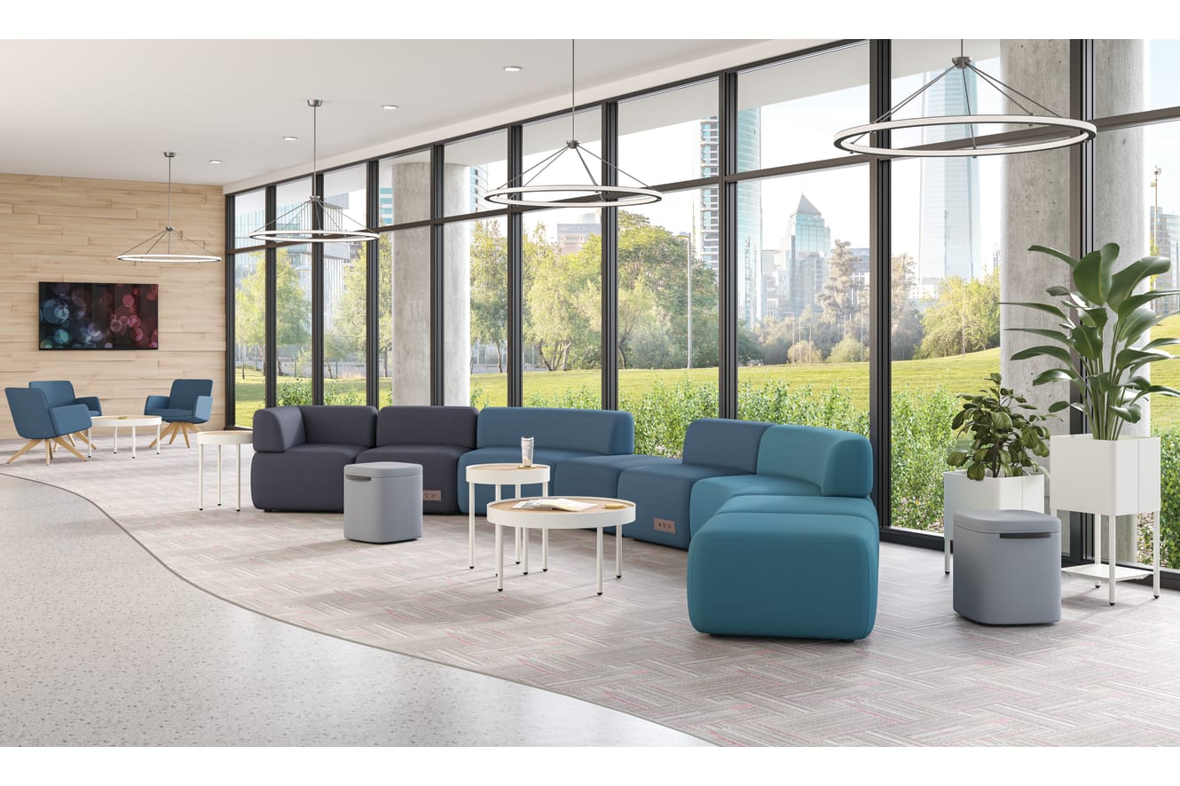 SoCo modular lounge in public space with Sculpt occasional tables & planters and Astir poufs.