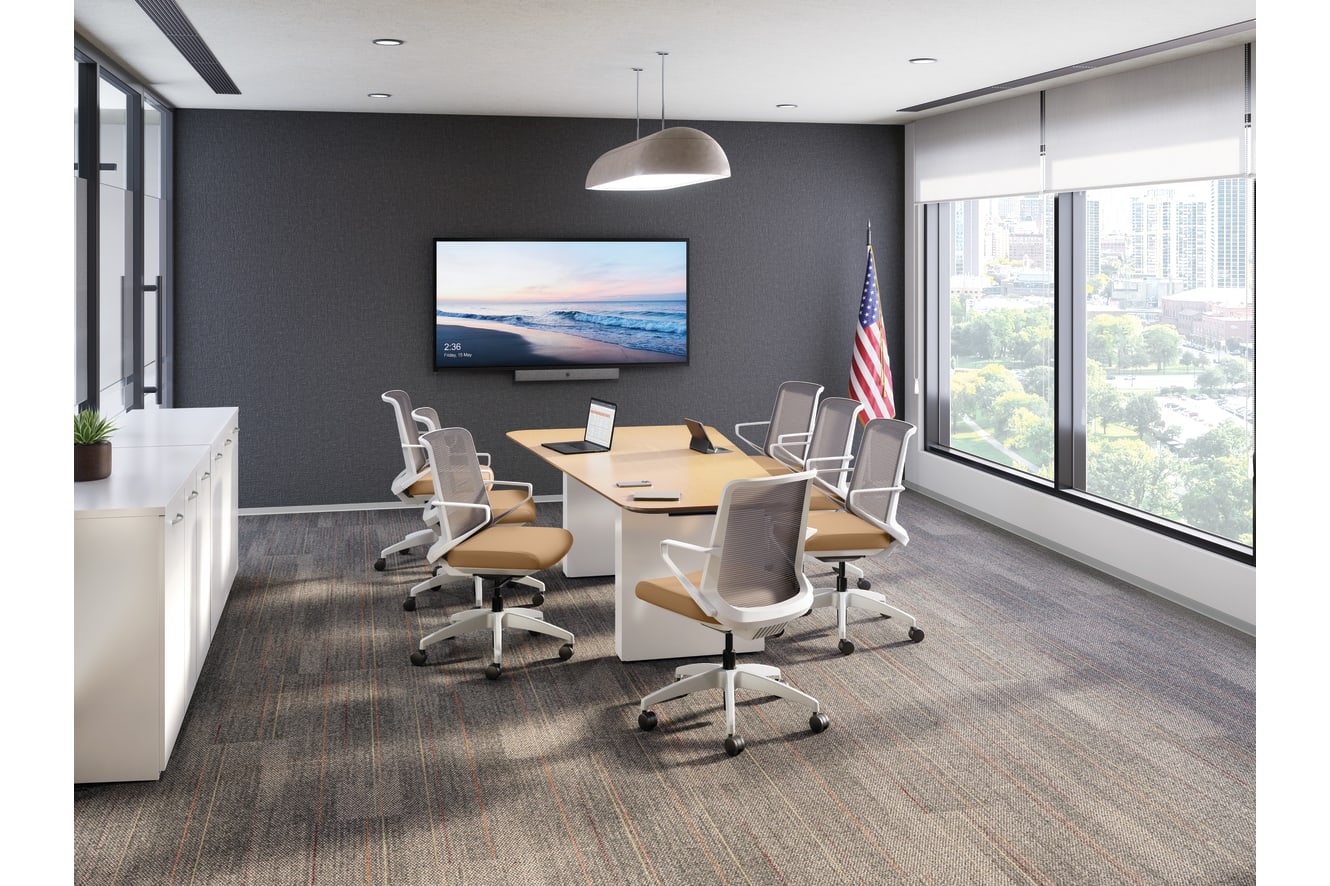 Contemporary conference room with rectangular meeting table, mesh office chairs, wall-mounted display, pendant lighting, large windows, and city view in a professional workspace.