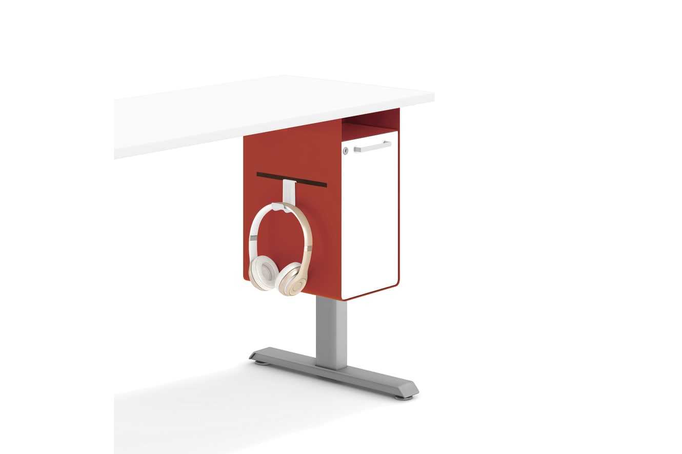 A red rectangular object with a white headphone attached to it, standing on a gray surface against a plain white background.