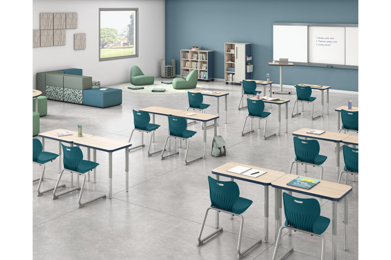 Classroom with flexible Build student desks, blue student chairs, and green soft seating.