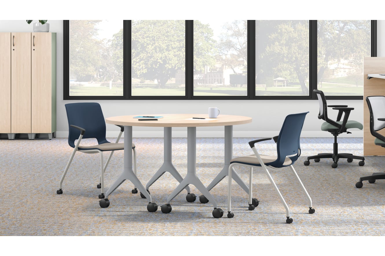 Open workstation view of Motivate 4-leg stacking and flex-back chair with Contain wardrobe locker and Motivate half-round table