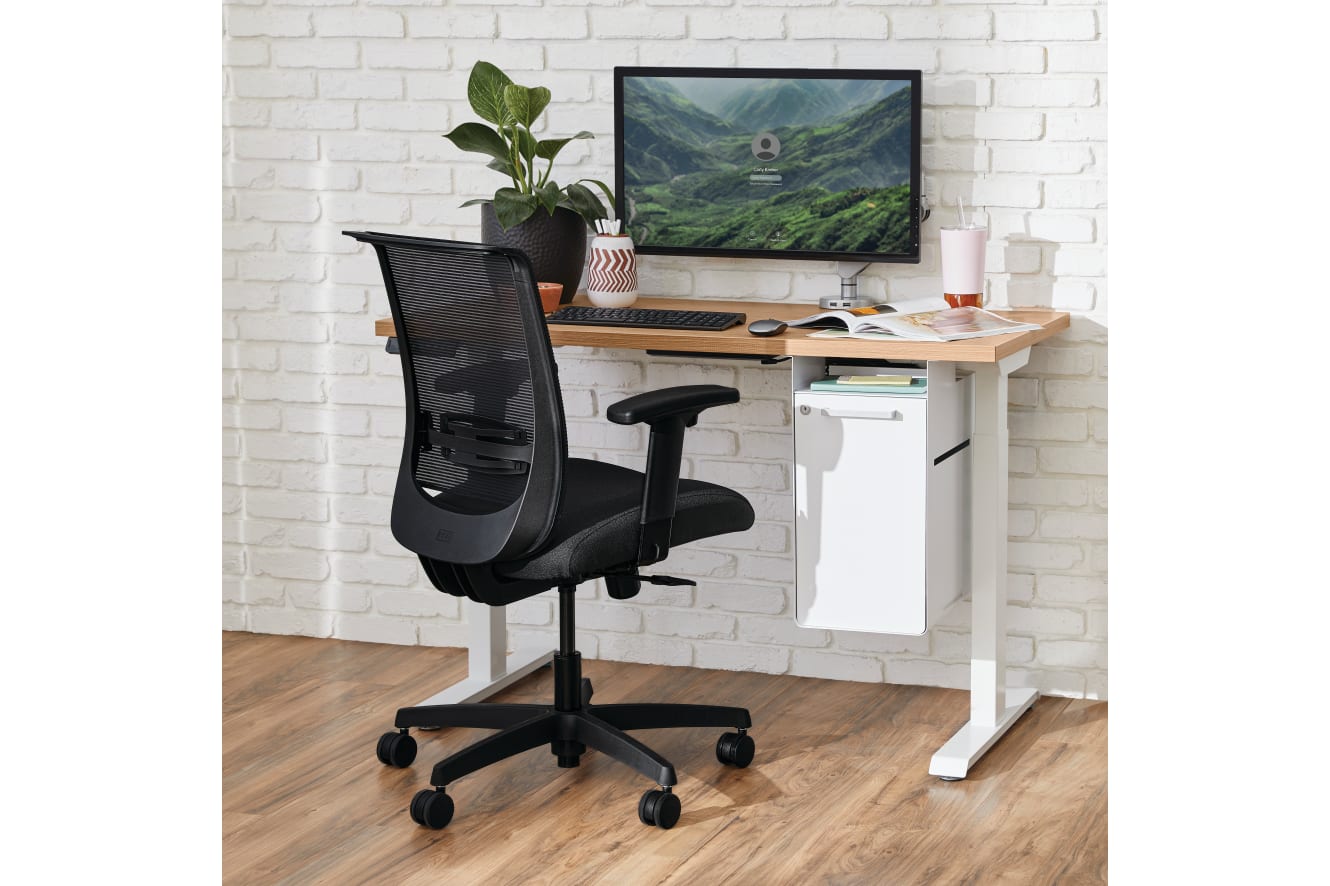 Two white Coordinate Height-Adjustable Bases paired with Coze desk tops and Convergence Task chairs in a small office setting