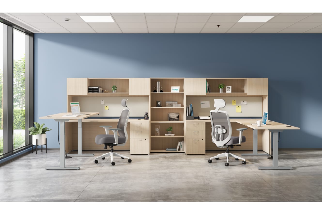 A modern and minimalist office space with desks, chairs, and shelving units arranged in a clean and organized manner, with large windows providing natural light.