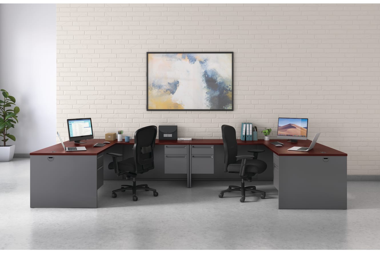 A modern and minimalist office space with two desks, chairs, computers, and a framed abstract artwork on the wall.
