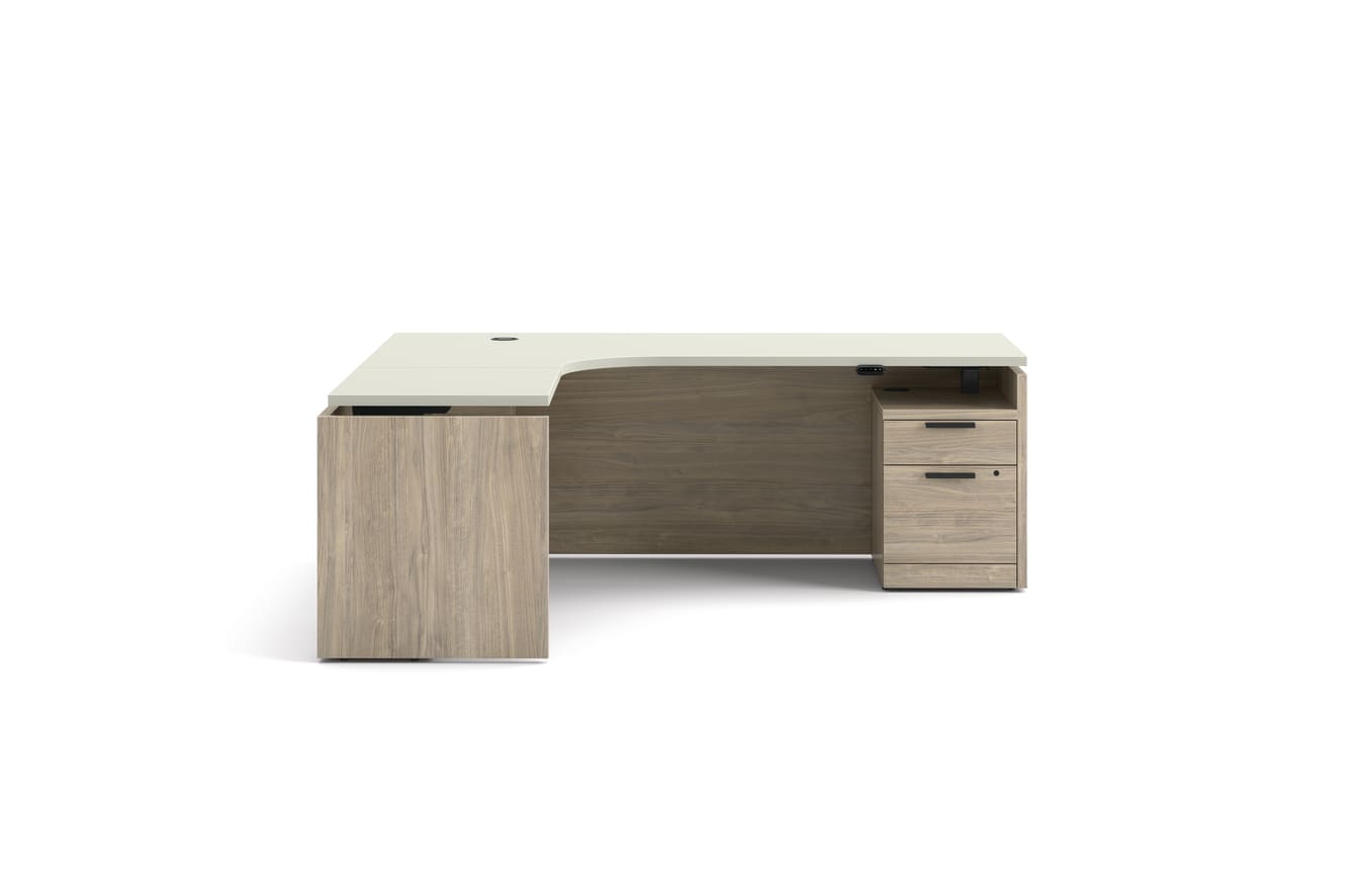 L-shaped executive desk with woodgrain finish, integrated power access, and pedestal storage in a modern two-tone design.