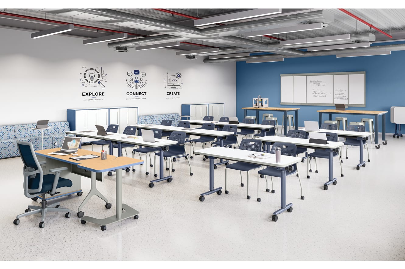 Flexible learning classroom with mobile student desks, rolling chairs, instructor workstation, whiteboards, collaborative seating, storage cabinets, and technology-ready workspace in a modern educational environment.