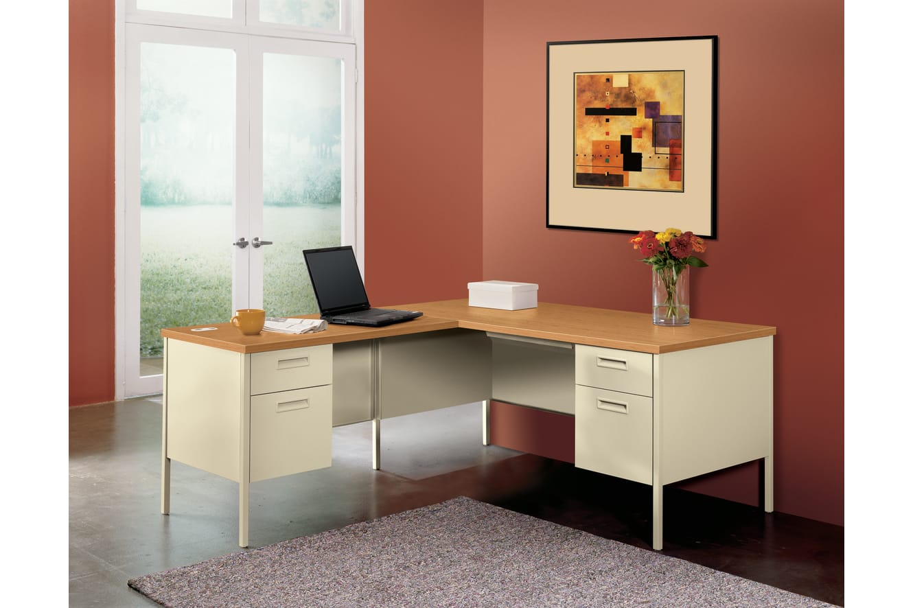 A modern and minimalist home office setup with a wooden desk, a laptop, and a decorative artwork on the wall, set against a warm-toned wall and a view of the outdoors through a window.