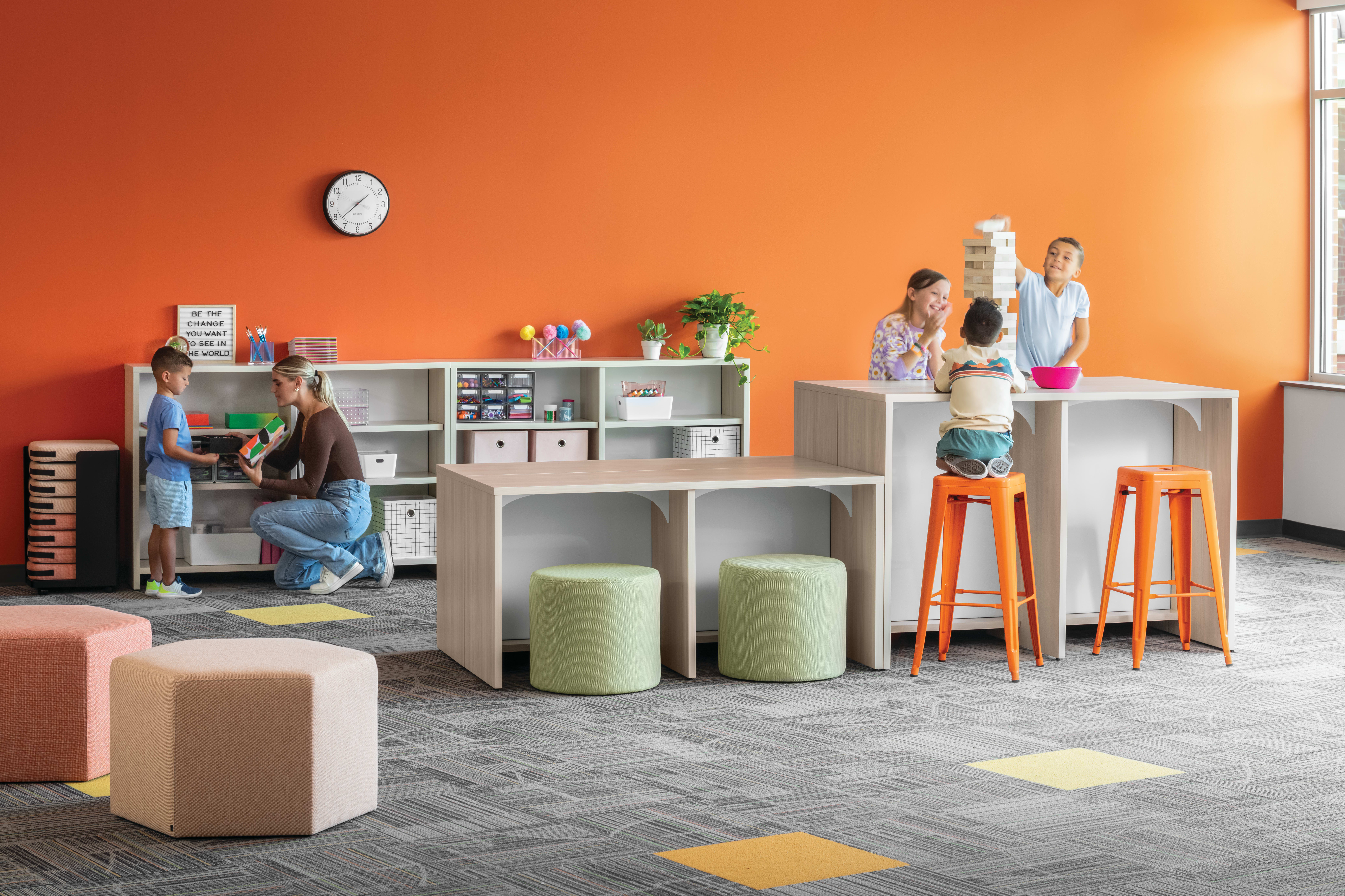 Storyline Linear Bookcases and Bistro Tables with Tangram Poufs and Flock Minis.
