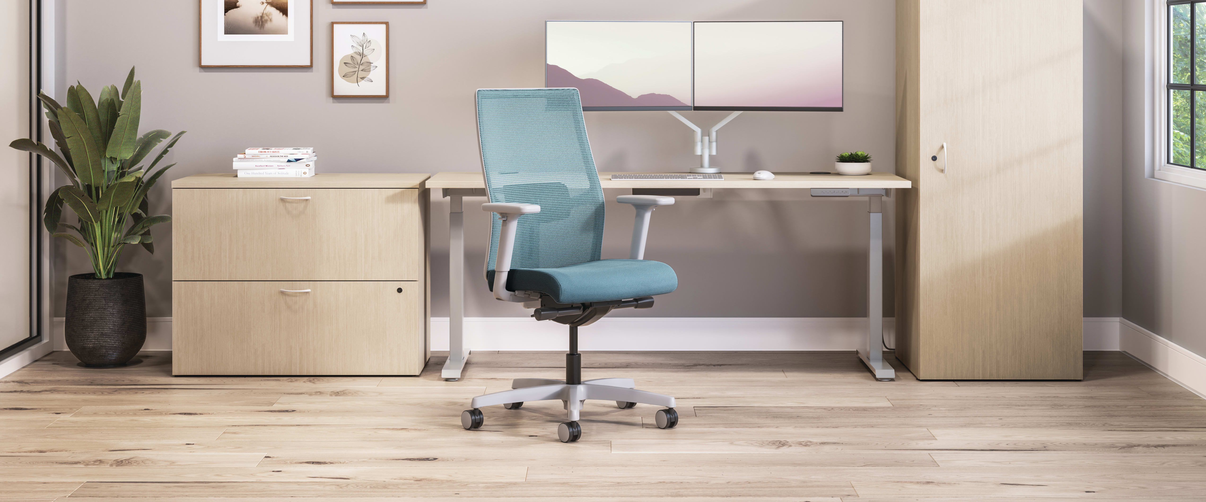 Private office featuring Mod desk with height adjustable table and Ignition task seating in blue fabric.