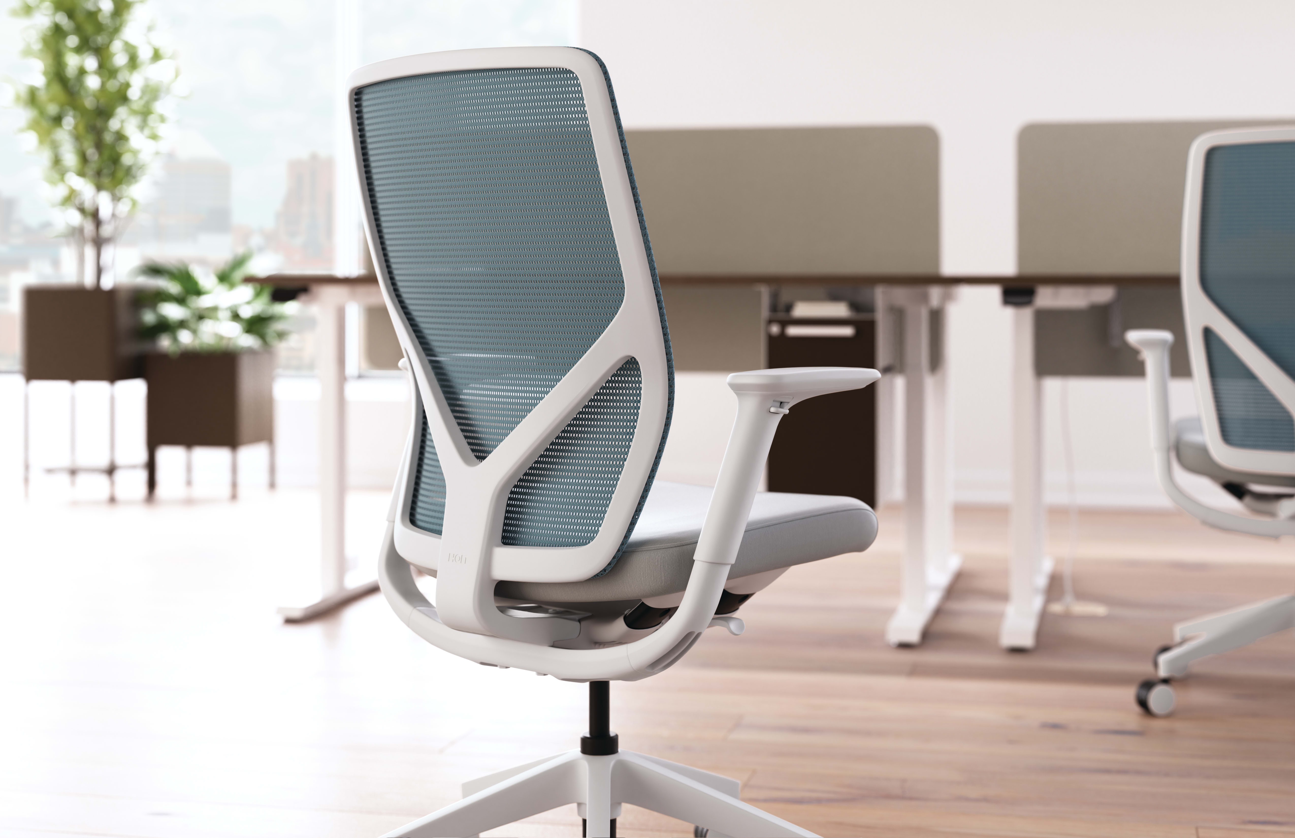 Flexion task chair with height adjustable workstations in background.