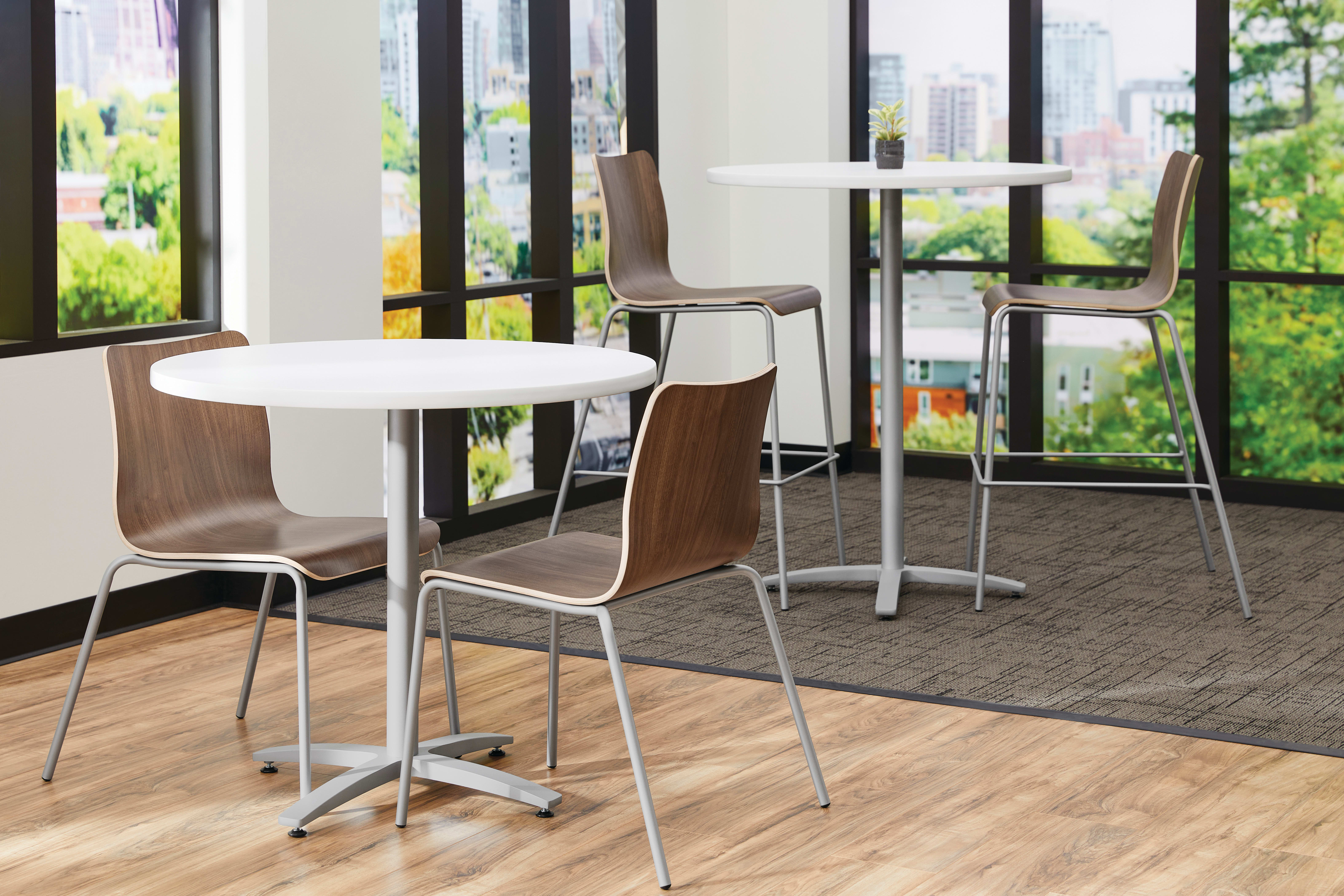 Between Standing and seated height tables with Ruck chairs in a café area