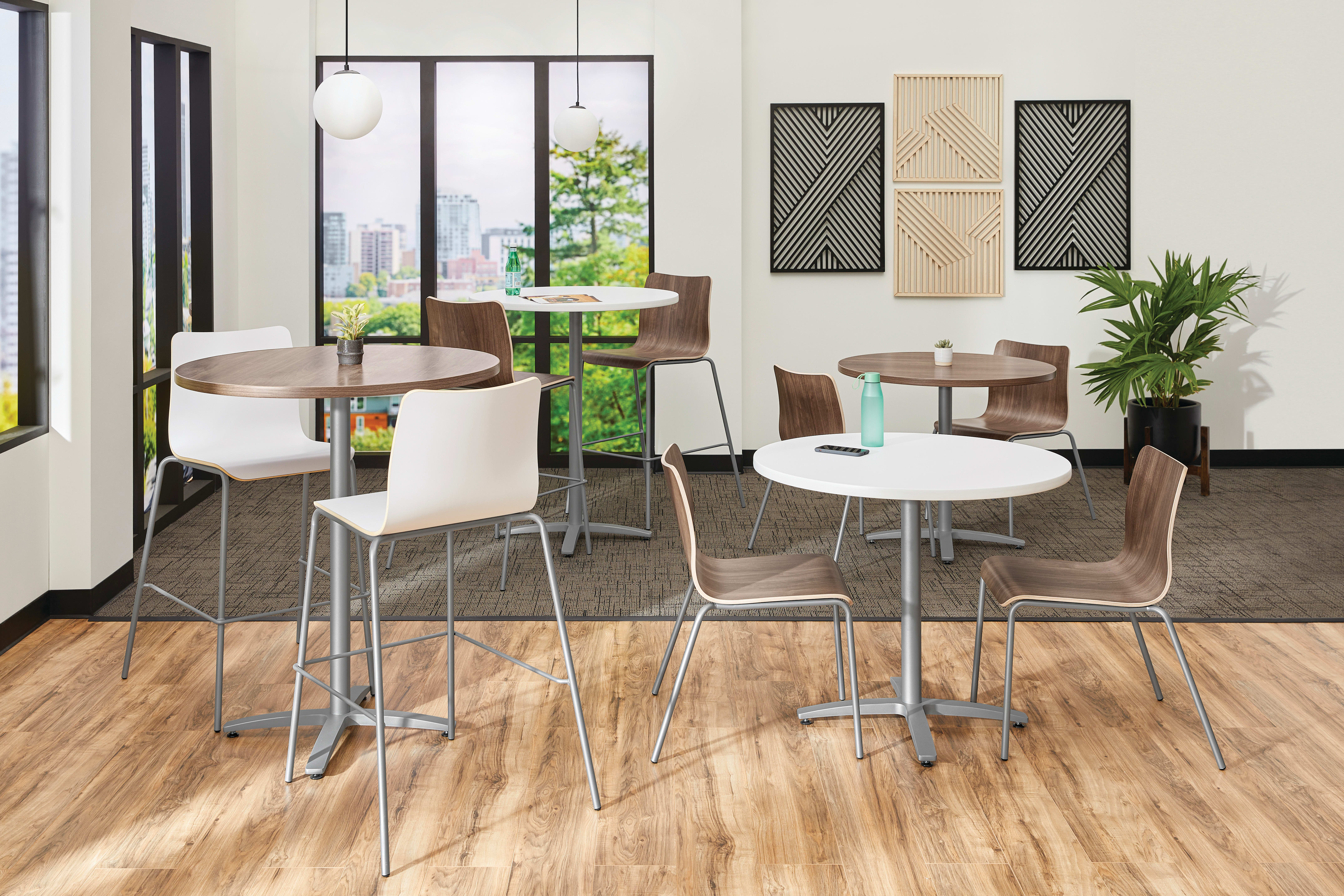 Between Standing and seated height tables with Ruck chairs in a café area