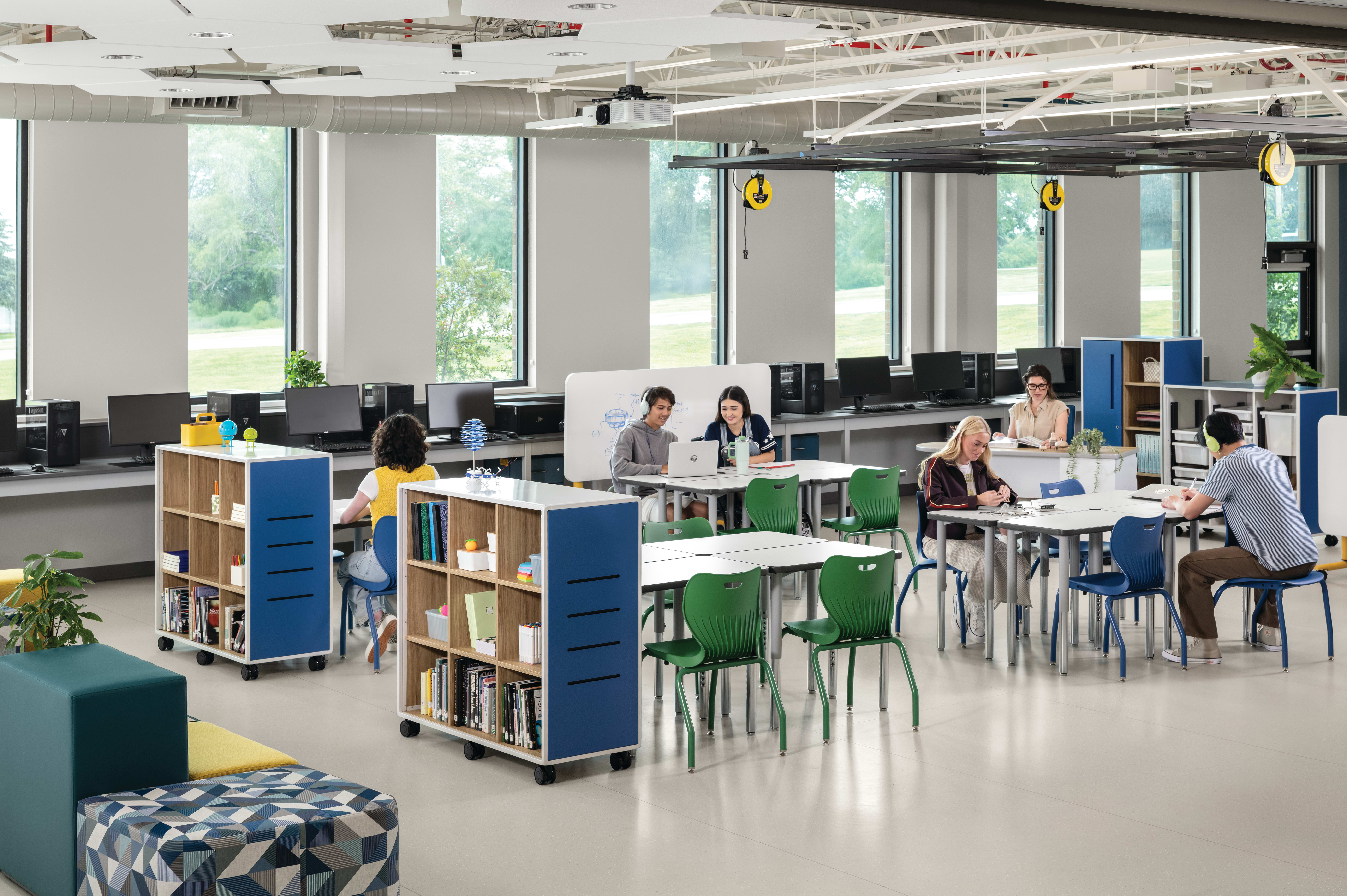 Students and teacher in a makerspace classroom with blue and green Smartlink chairs and blue Class-ifi storage solutions.