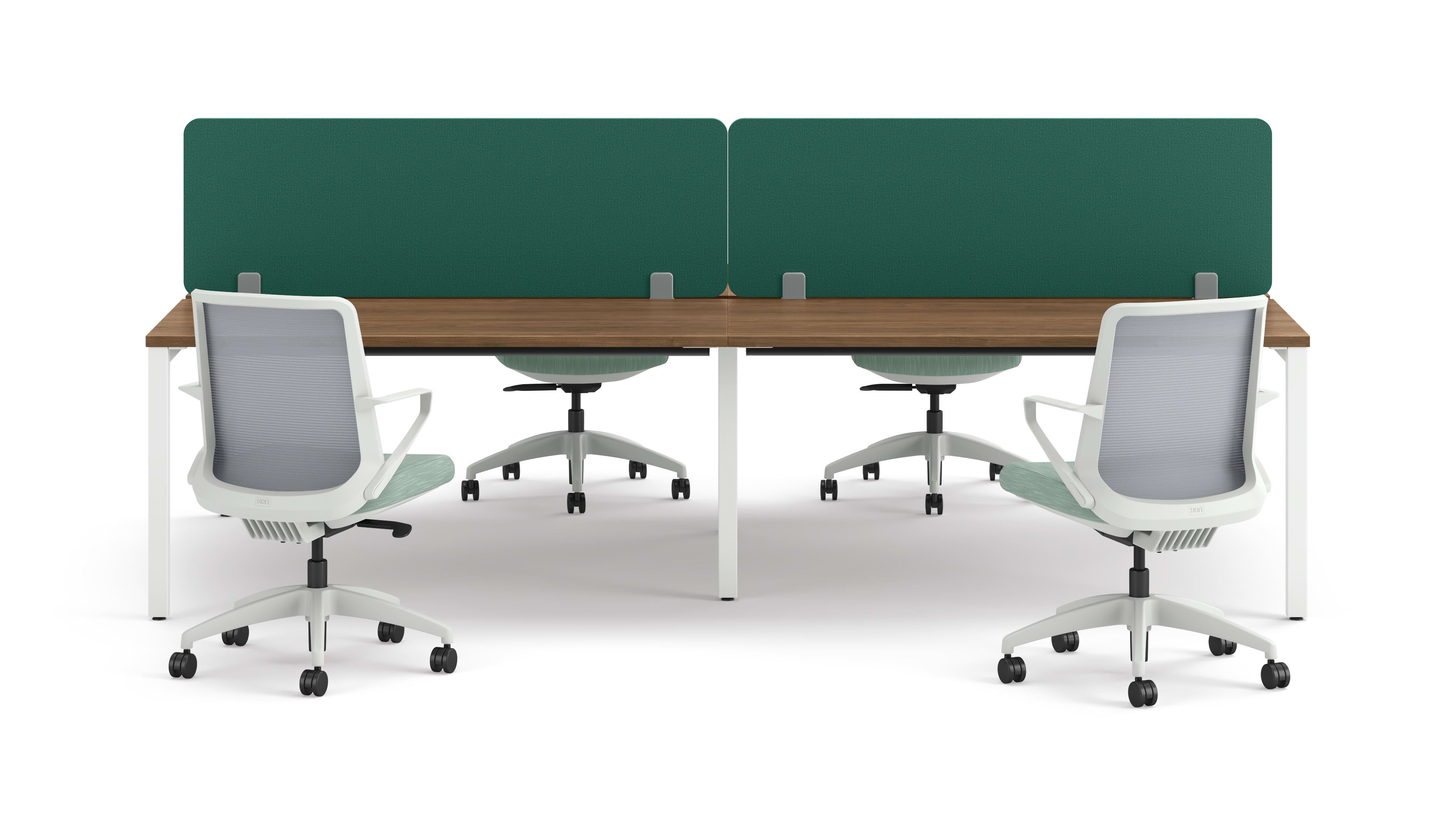 Four ergonomic office chairs positioned around two connected desks with wooden tops, white legs, and green fabric privacy panels.