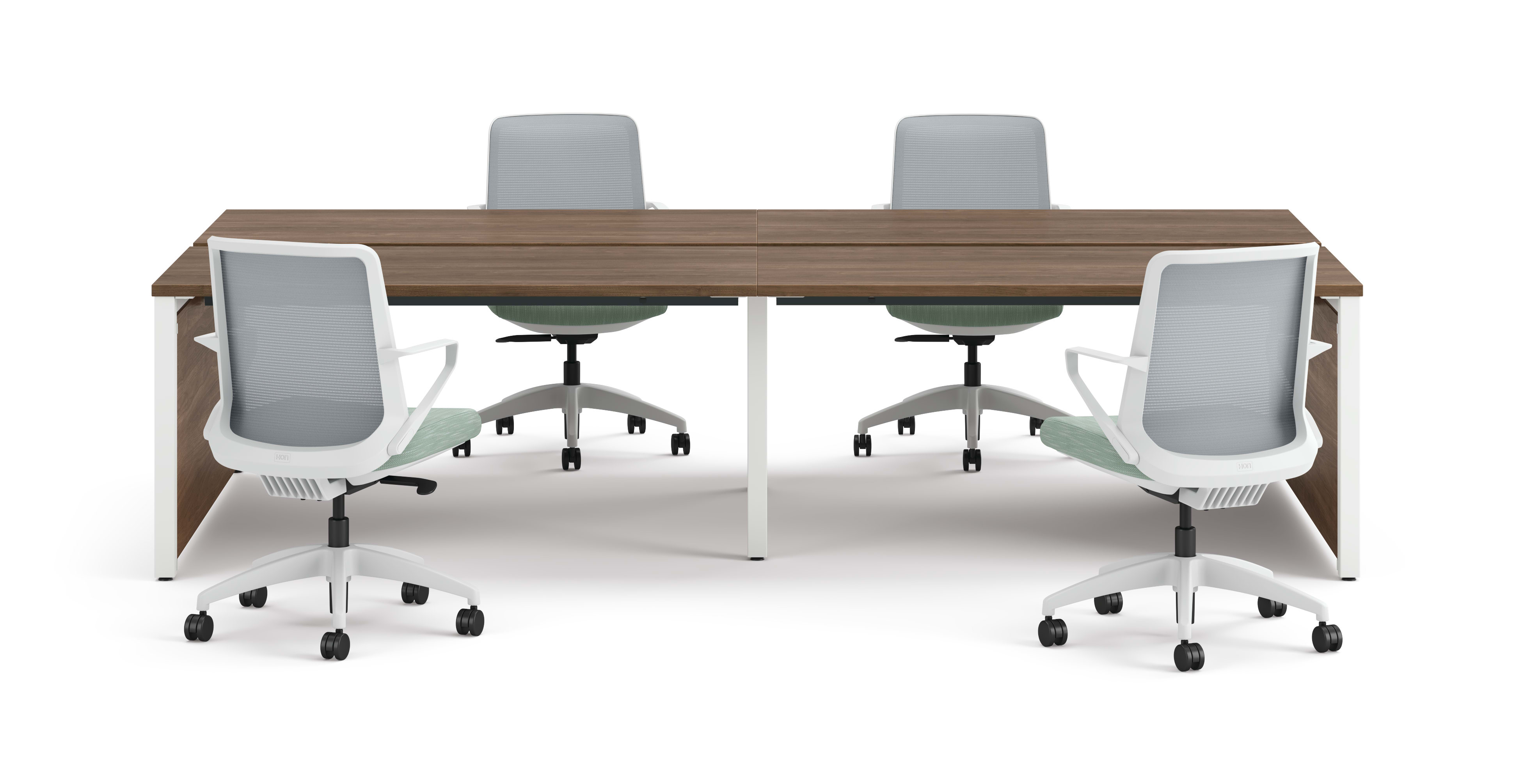 Four ergonomic office chairs arranged around two connected rectangular desks with wooden tops and white legs.