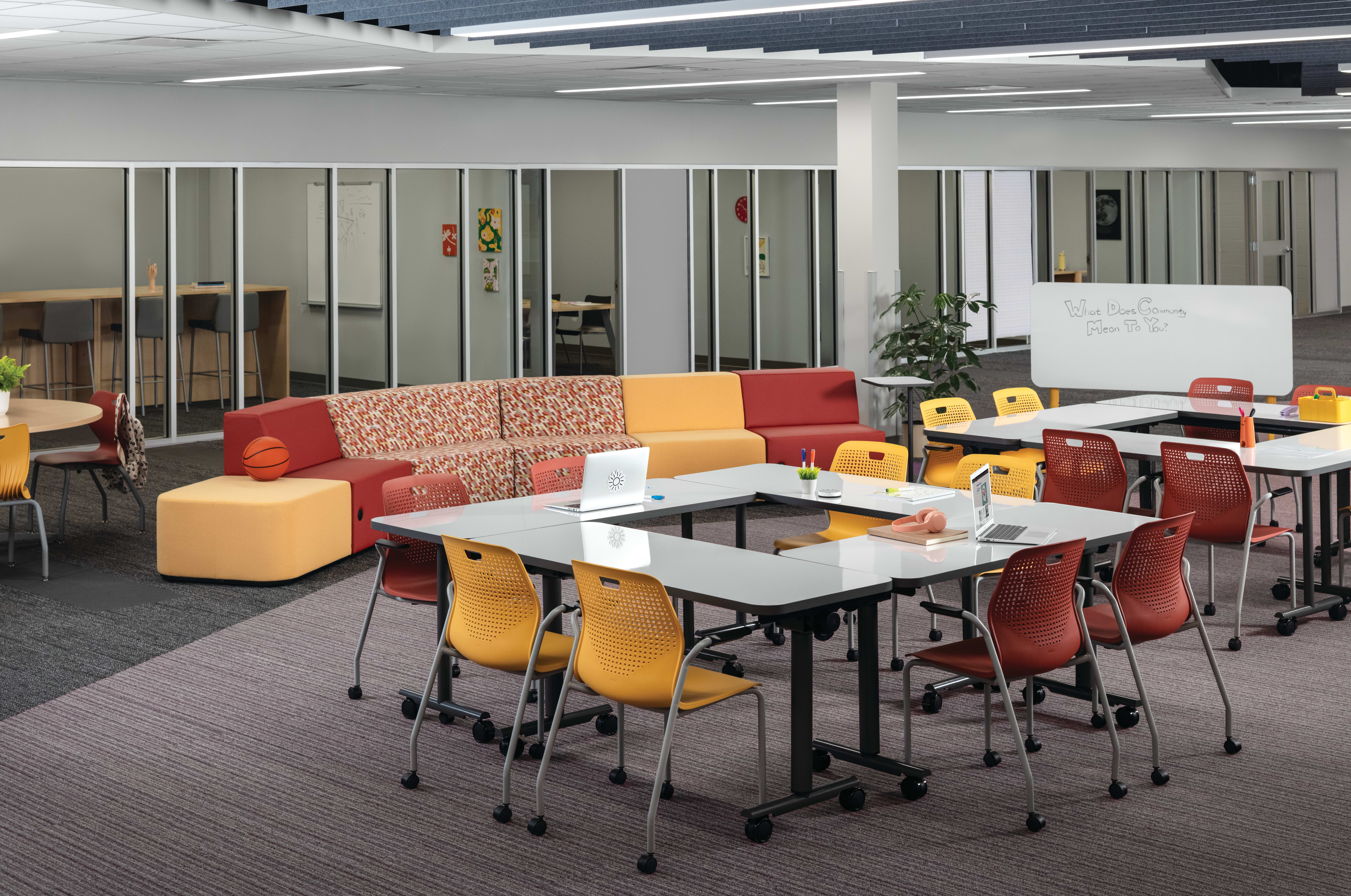 Field Trip tables with red and yellow Etch chairs in a Multi-media Center with Tangram seating.