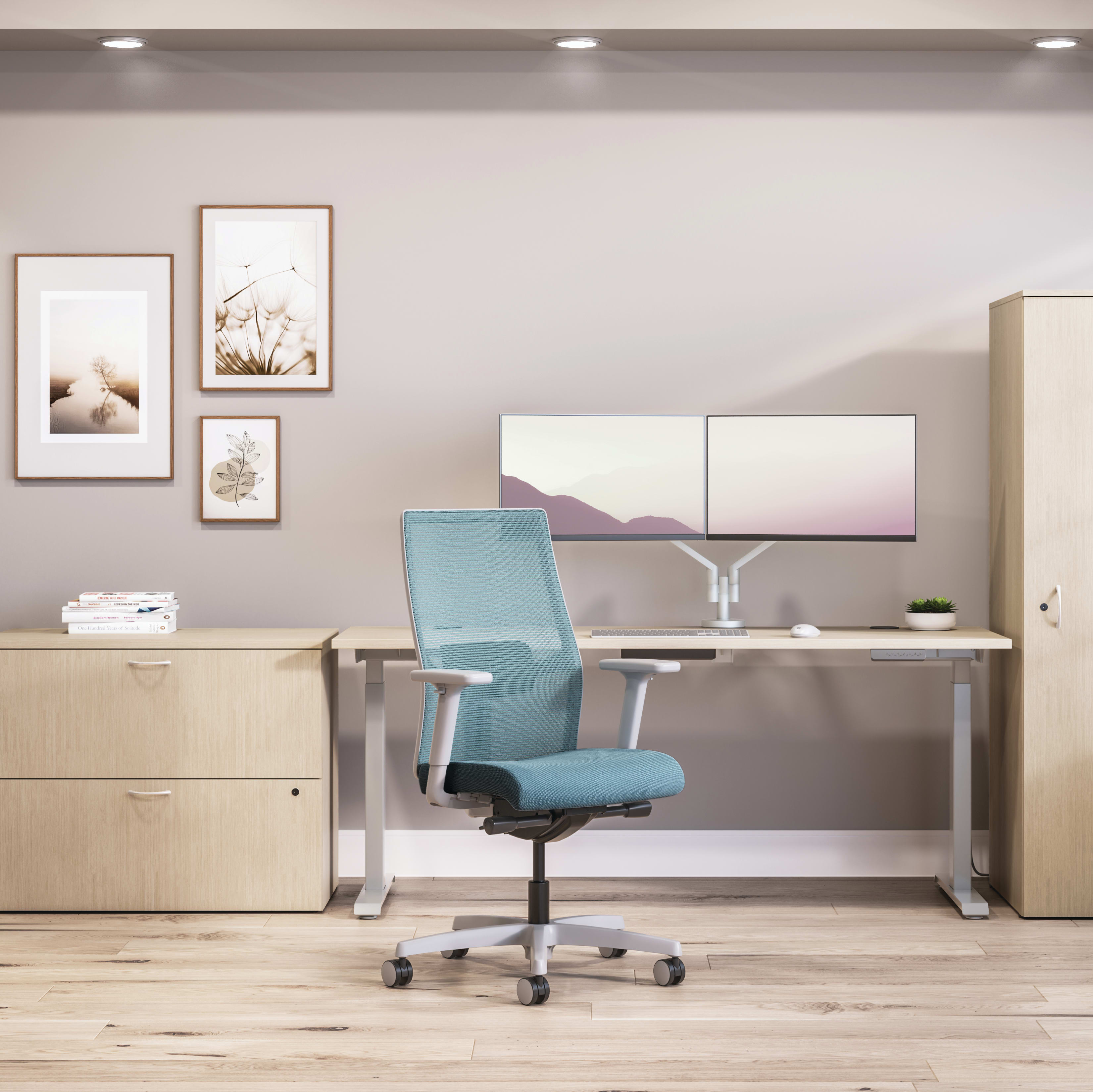 Private office featuring Mod desk with height adjustable table and Ignition task seating in blue fabric.