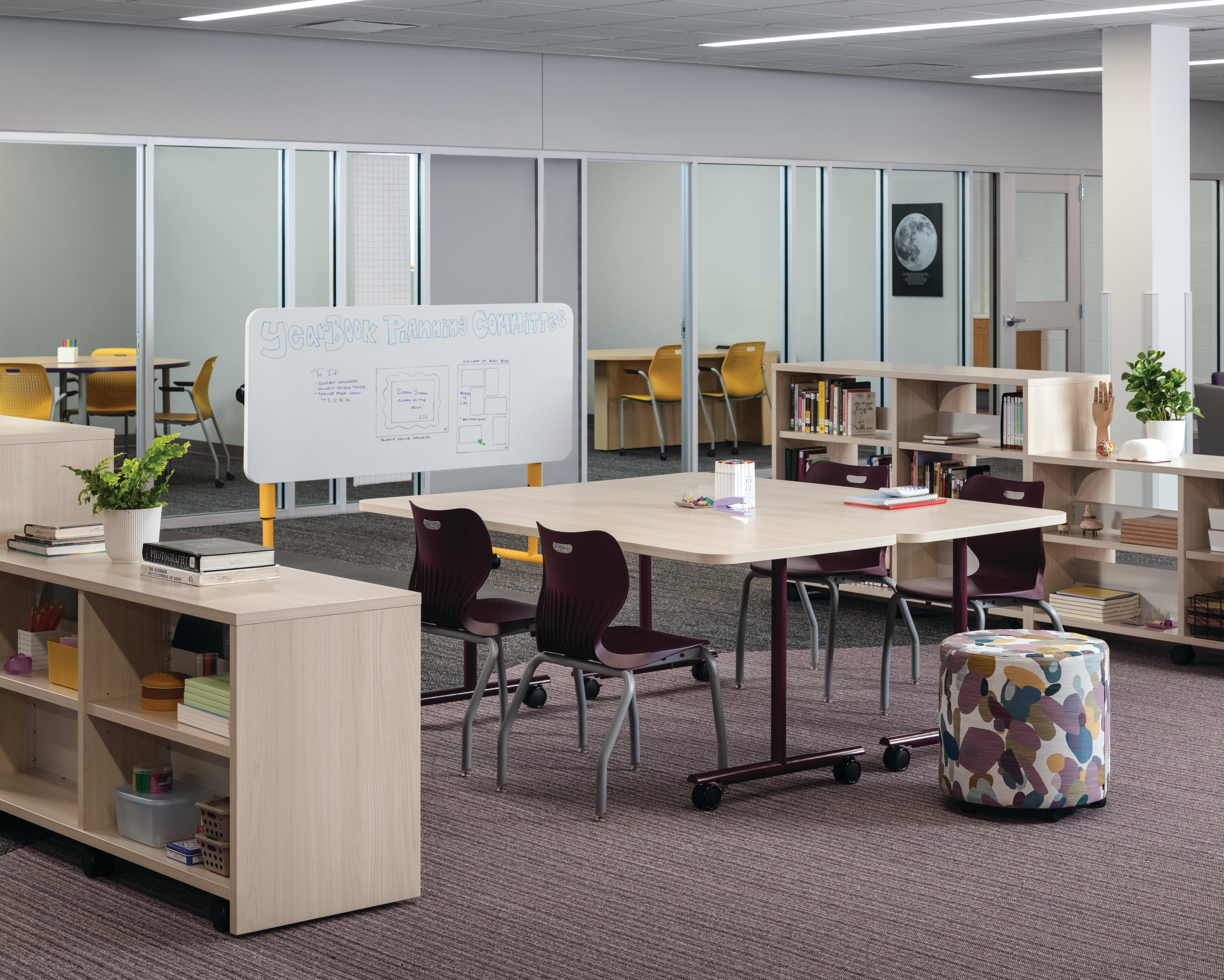 Field Trip tables with purple SmartLink chairs in a Multi-media Center with Storyline bookcases.