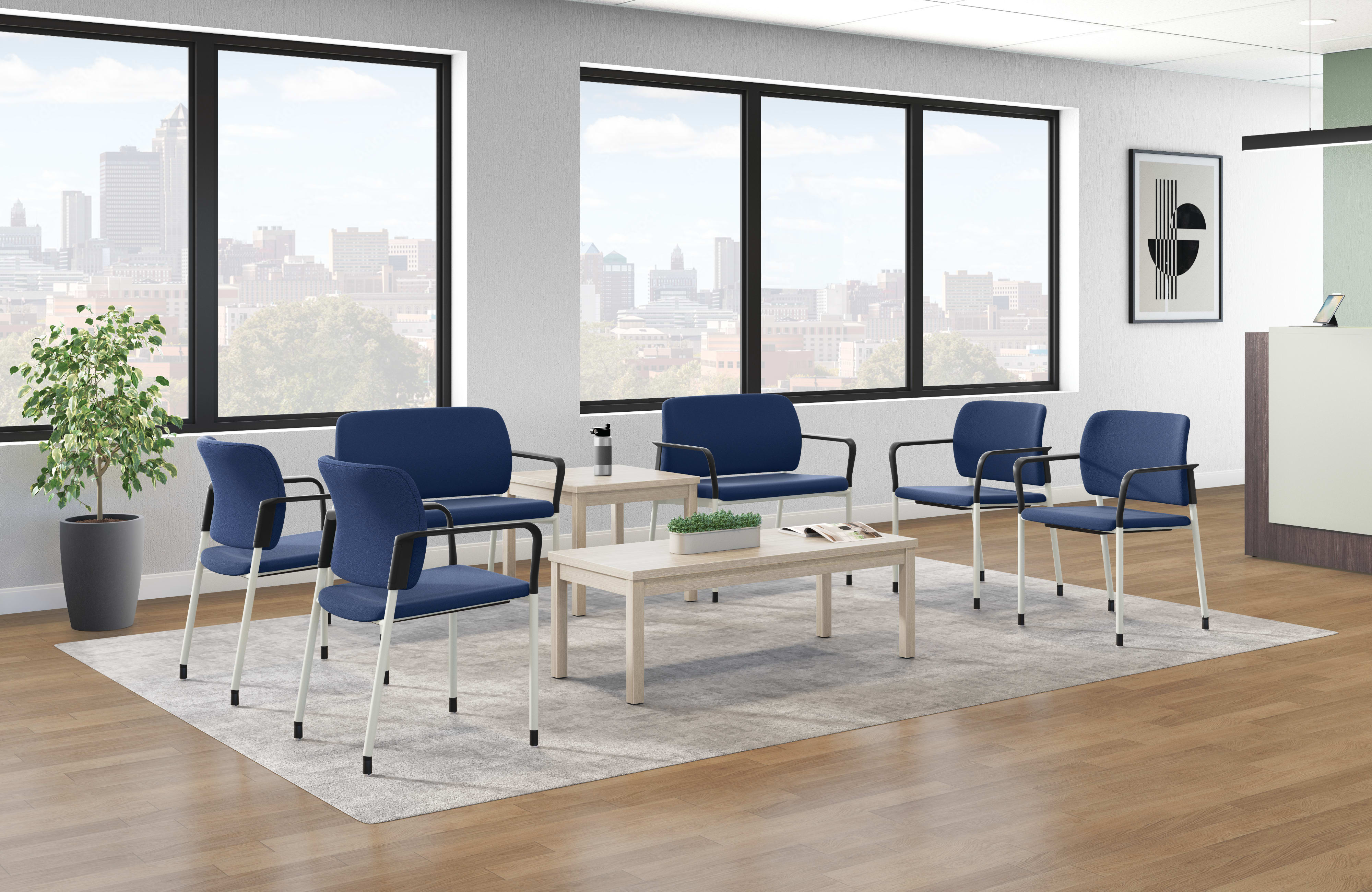 Modern waiting area with blue upholstered chairs, light wood tables, large windows, and decorative plant.
