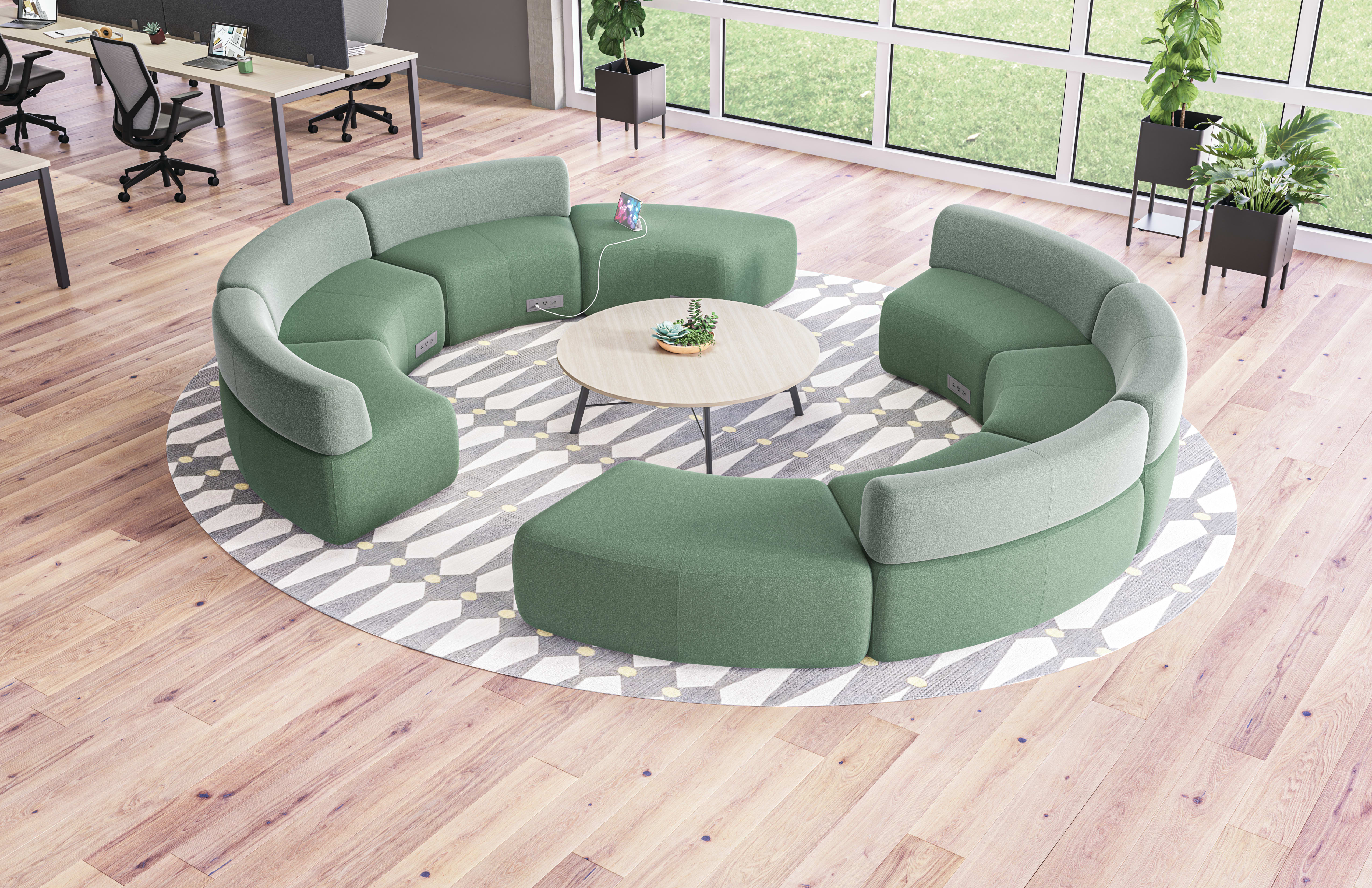 SoCo multi-fabric modular lounge in collaborative area with Scramble table and Sculpt planters near Empower workstations.