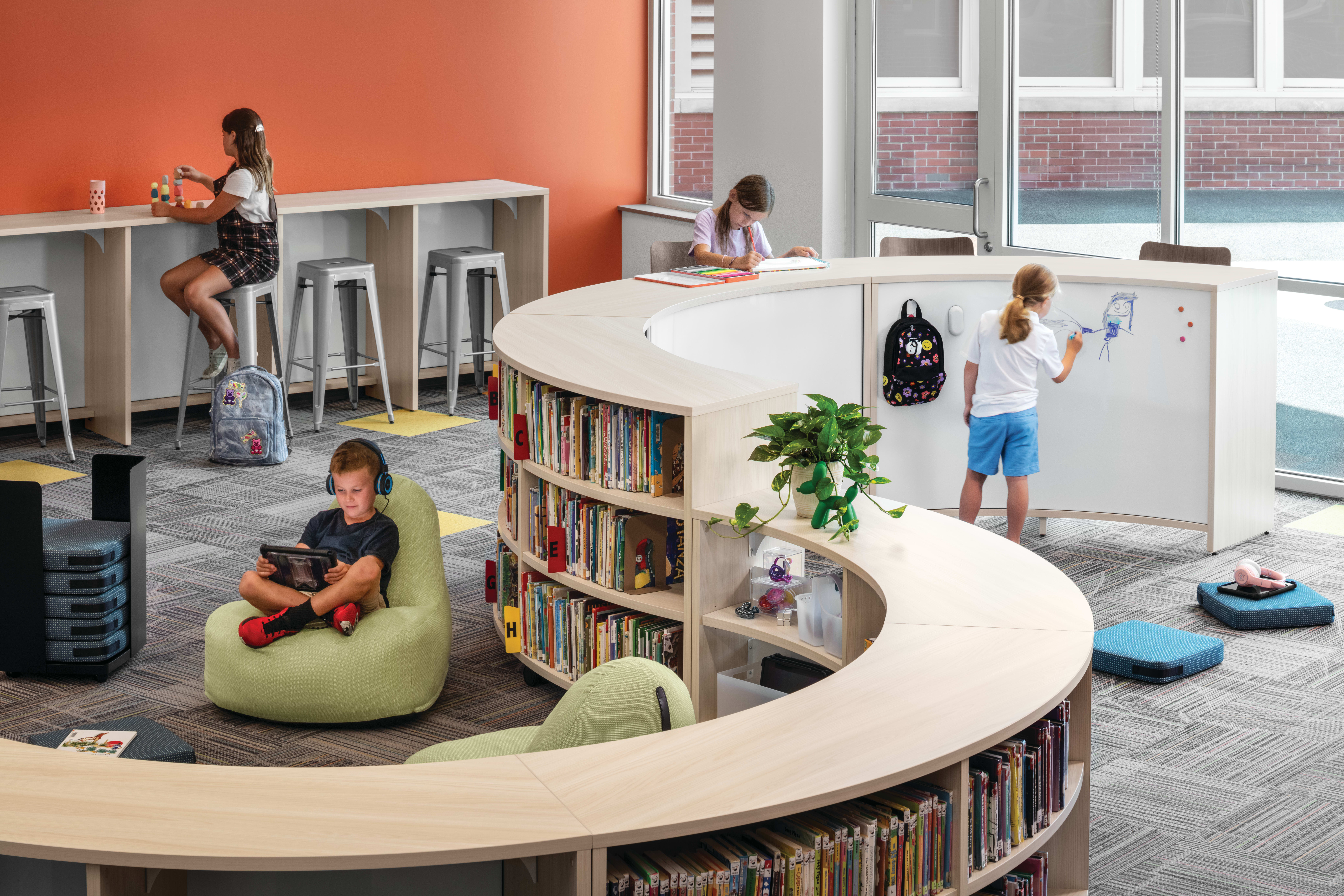 Storyline Bookcases and Bistro Tables with Confetti Floor Cushions and Lounges.