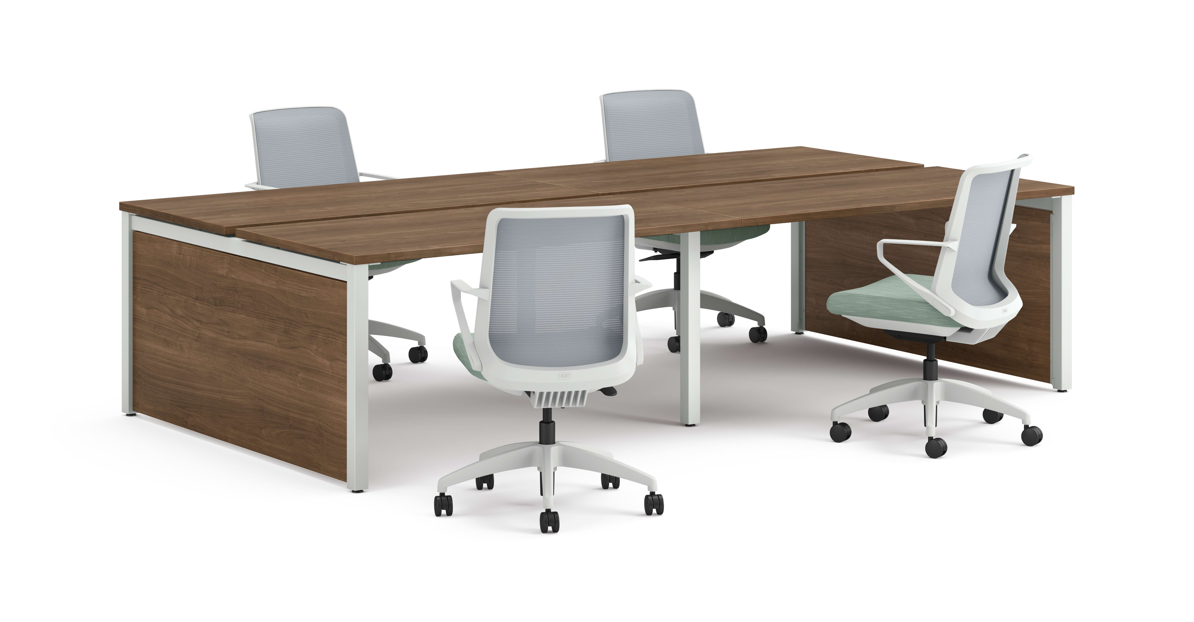 Four ergonomic office chairs arranged around two connected rectangular desks with wooden tops and white legs.