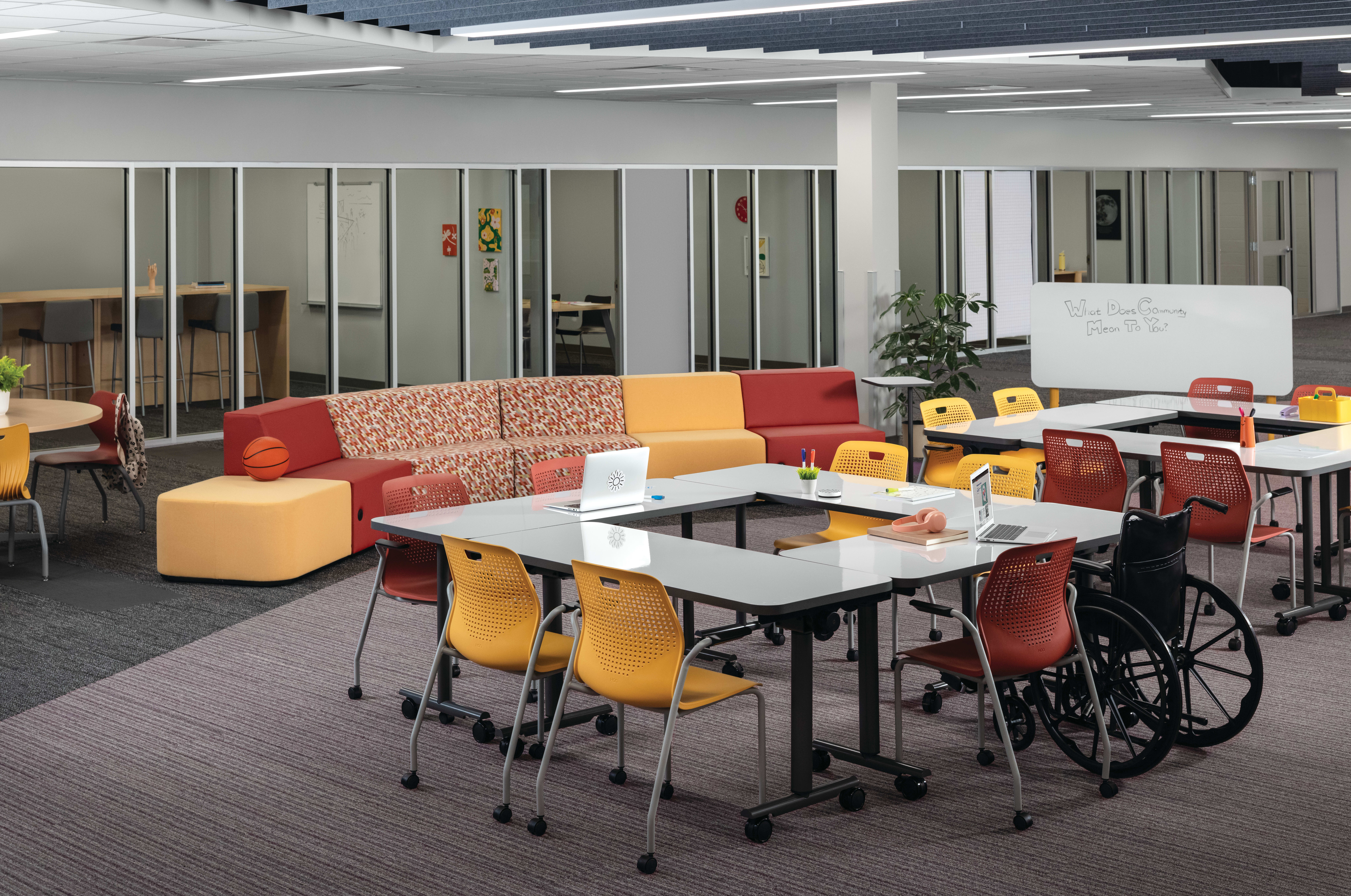 Field Trip tables with red and yellow Etch chairs in a Multi-media Center with Tangram seating.