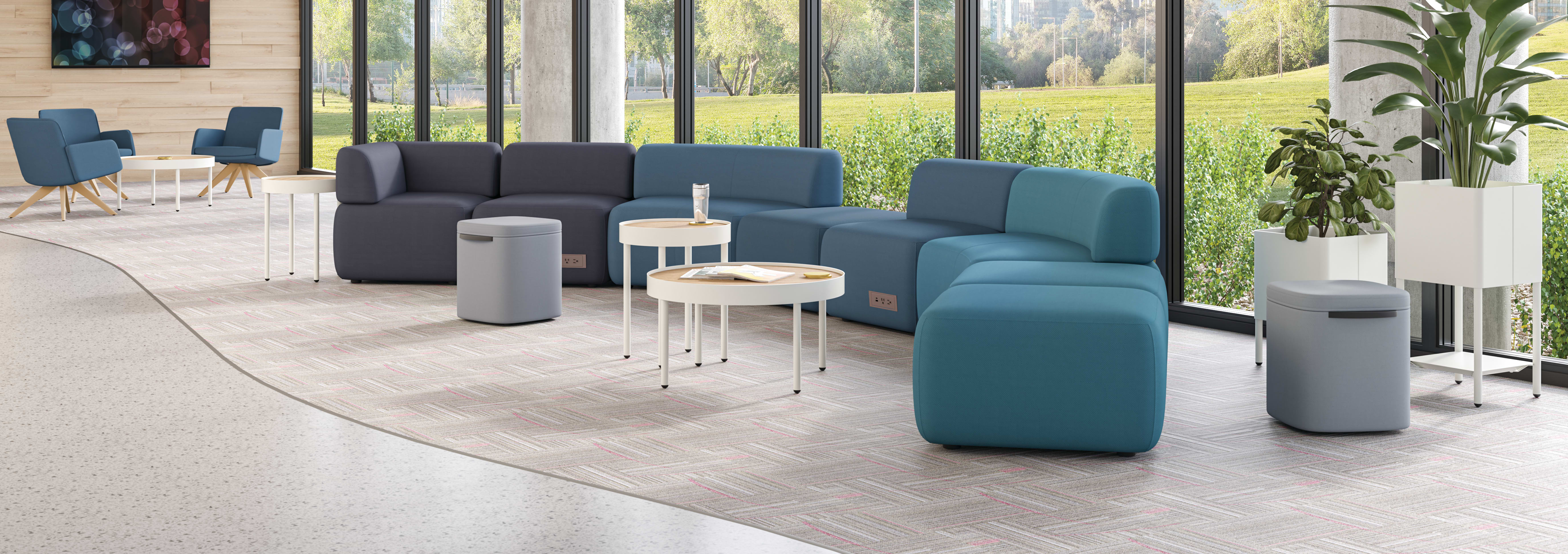 SoCo modular lounge in public space with Sculpt occasional tables & planters and Astir poufs.