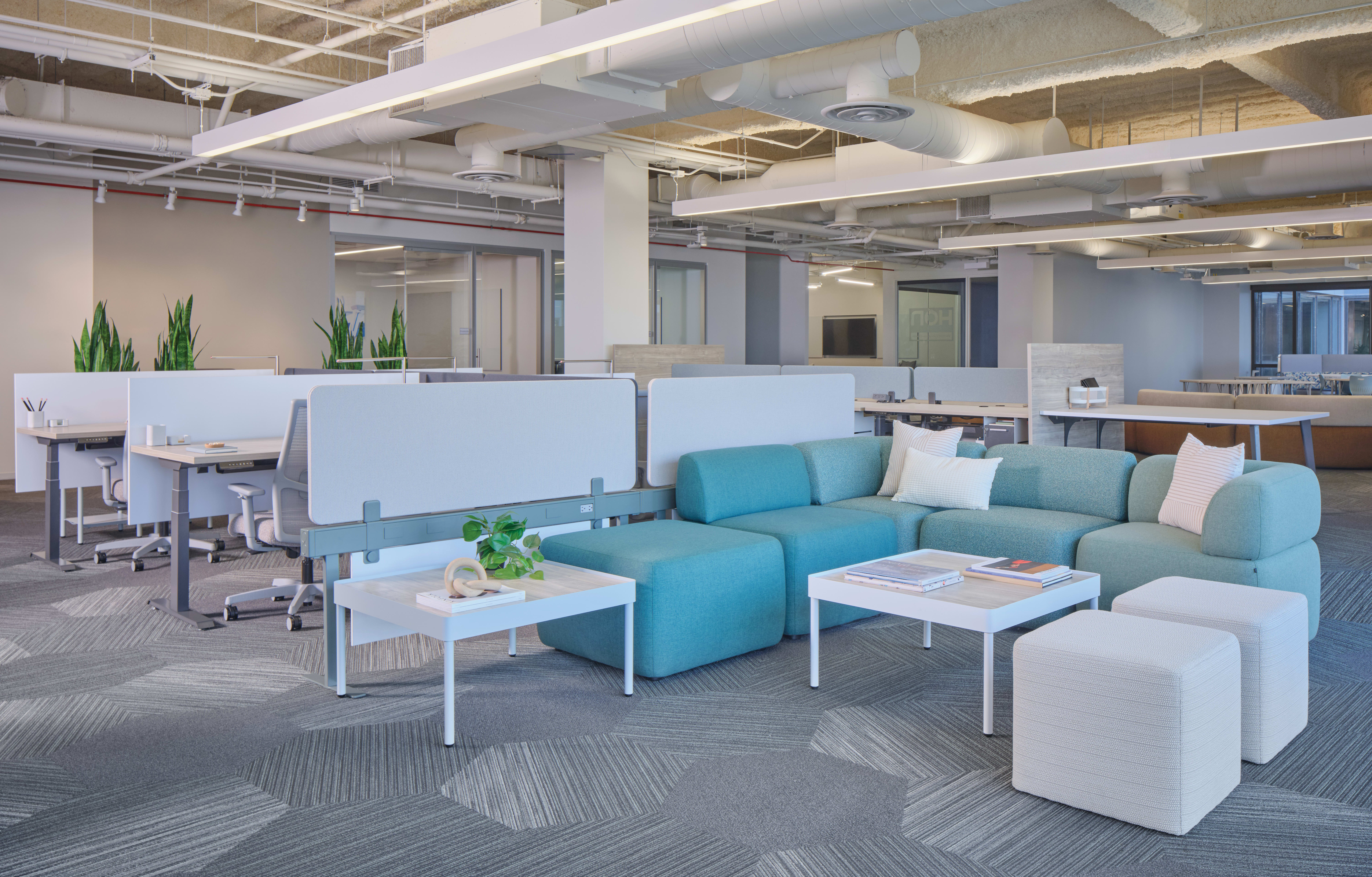 SocCo shown with Sculpt tables and Flock lounge seats, next to Gravitation power beam & screens with Coordinate height adjustable desks, fuse storage, and ignition 2.0 seating. 