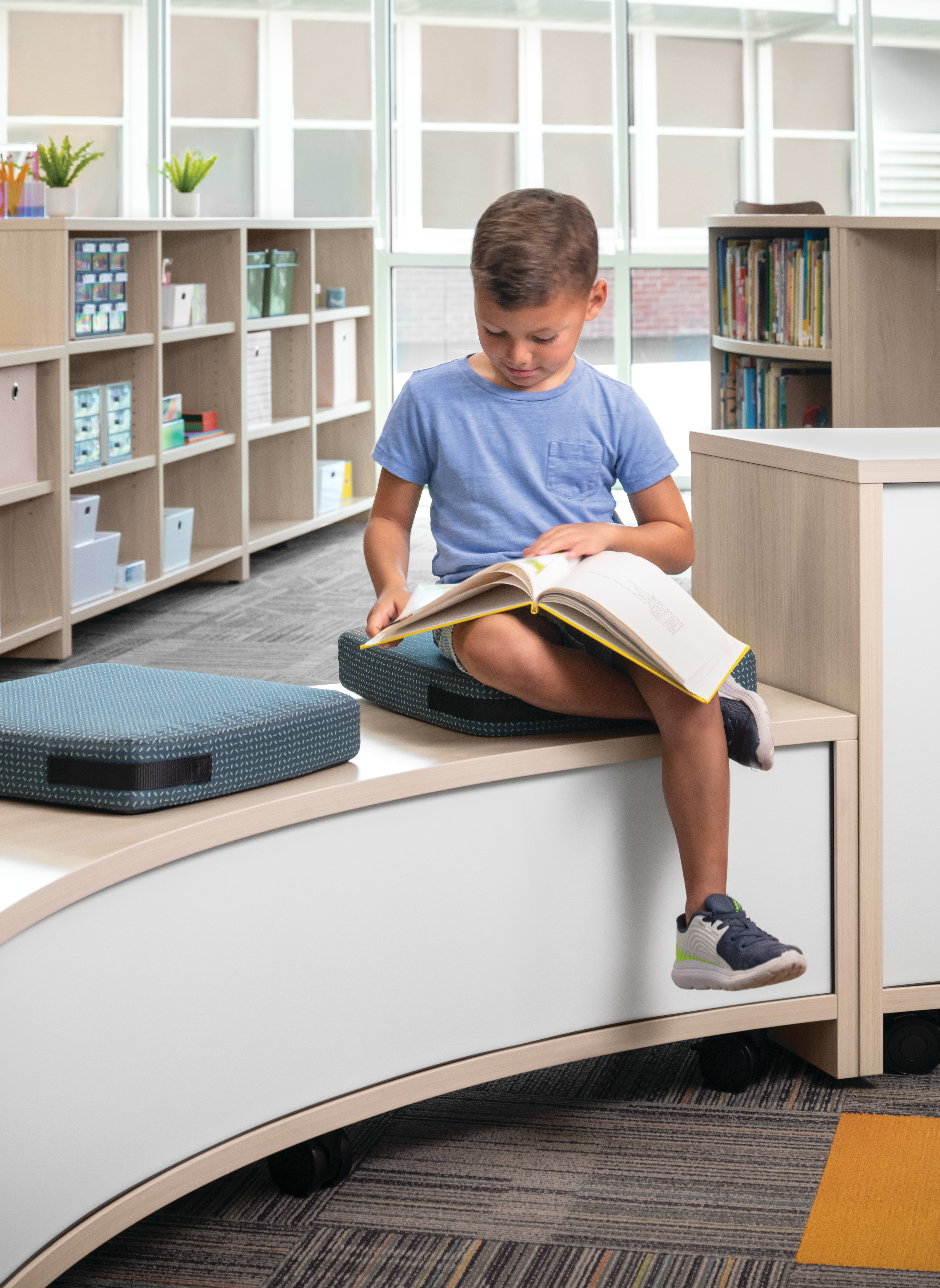 Storyline Bookcases and Bistro Tables with Confetti Floor Cushions.
