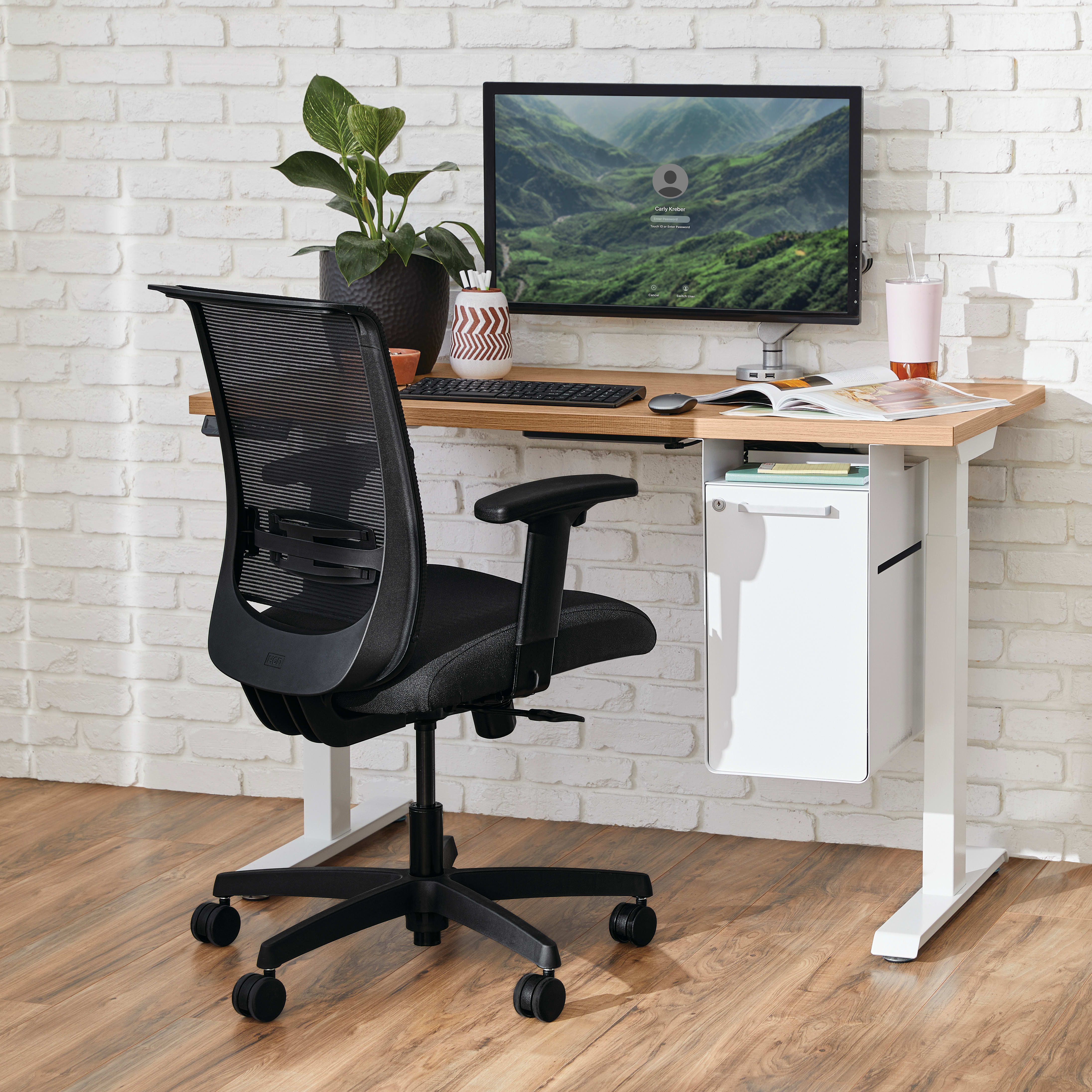 Two white Coordinate Height-Adjustable Bases paired with Coze desk tops and Convergence Task chairs in a small office setting
