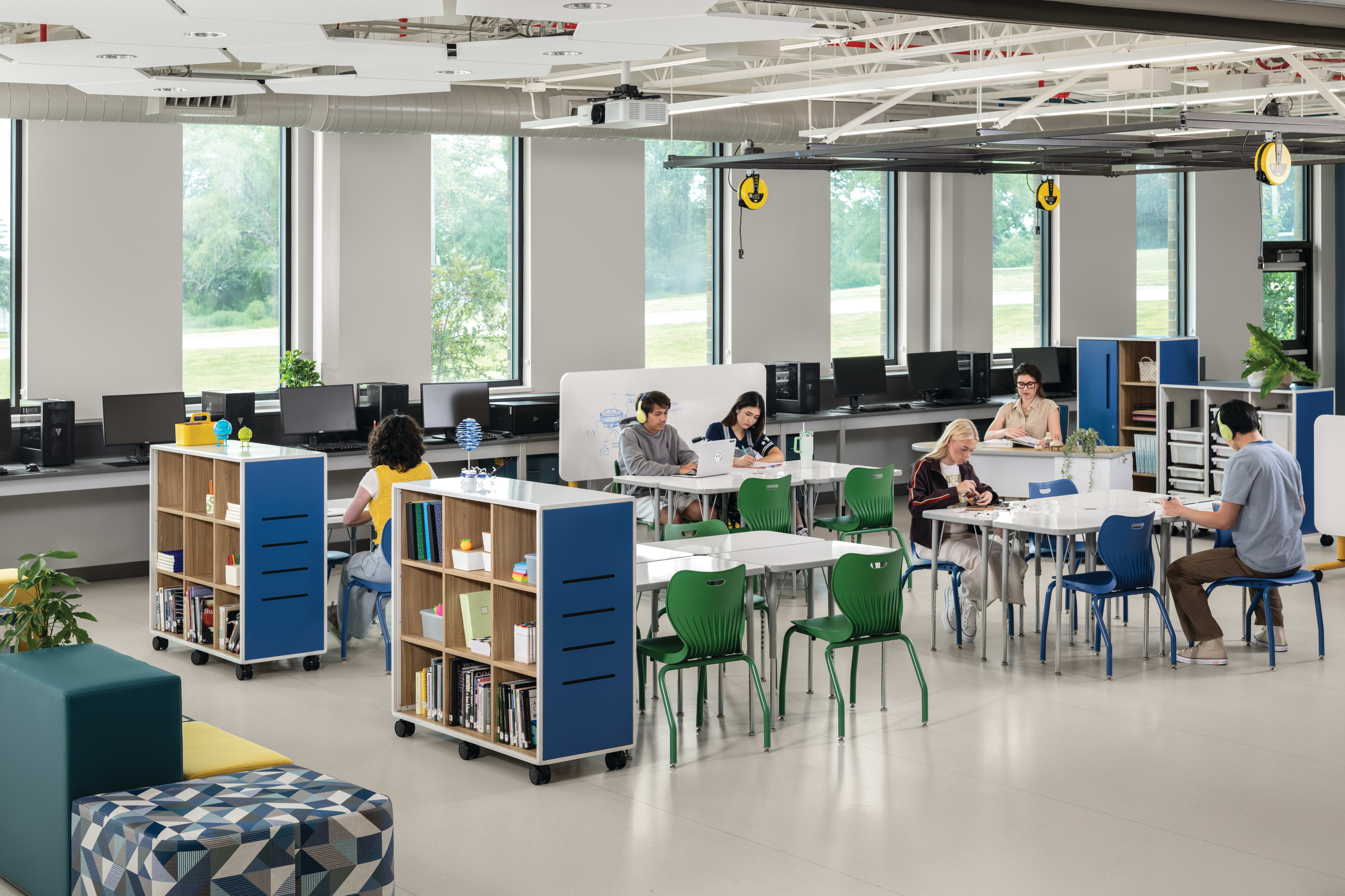 Students and teacher in a makerspace classroom with blue and green Smartlink chairs and blue Class-ifi storage solutions.
