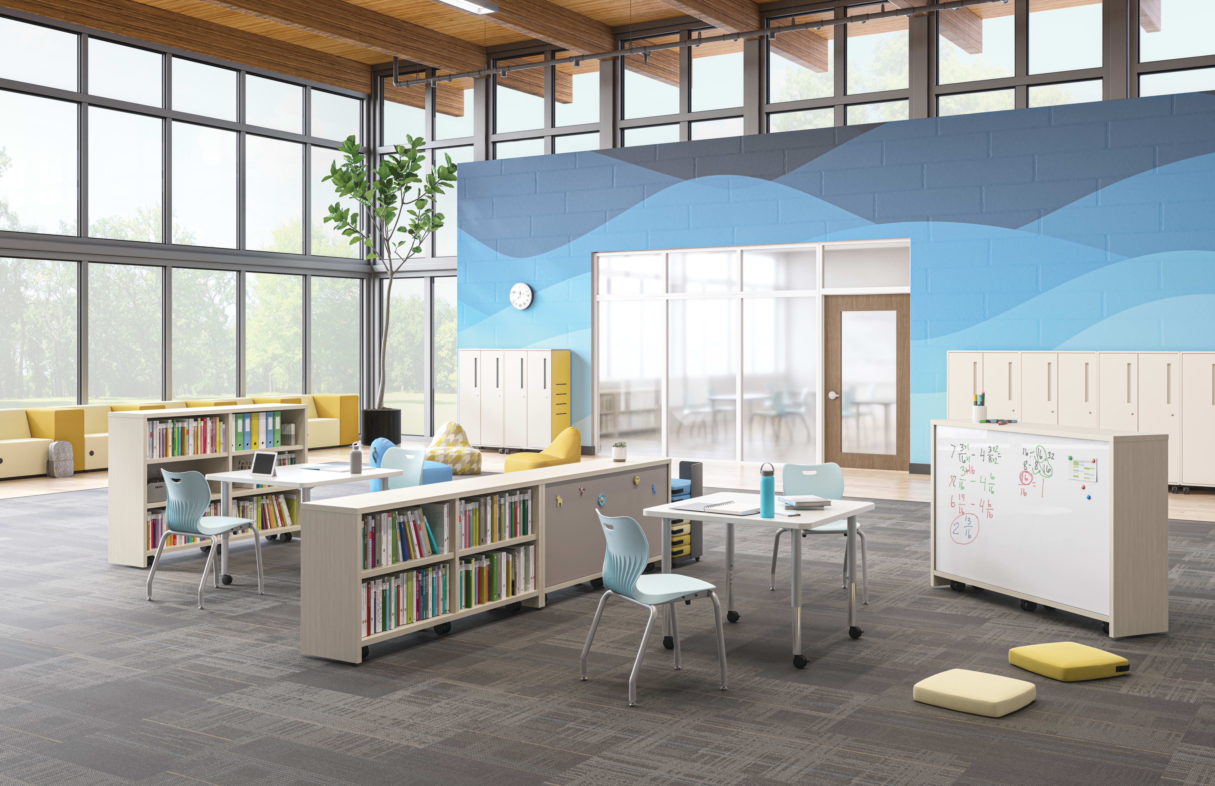 Open space outside of a classroom featuring Storyline bookcases and Build tables as a place for students to study.