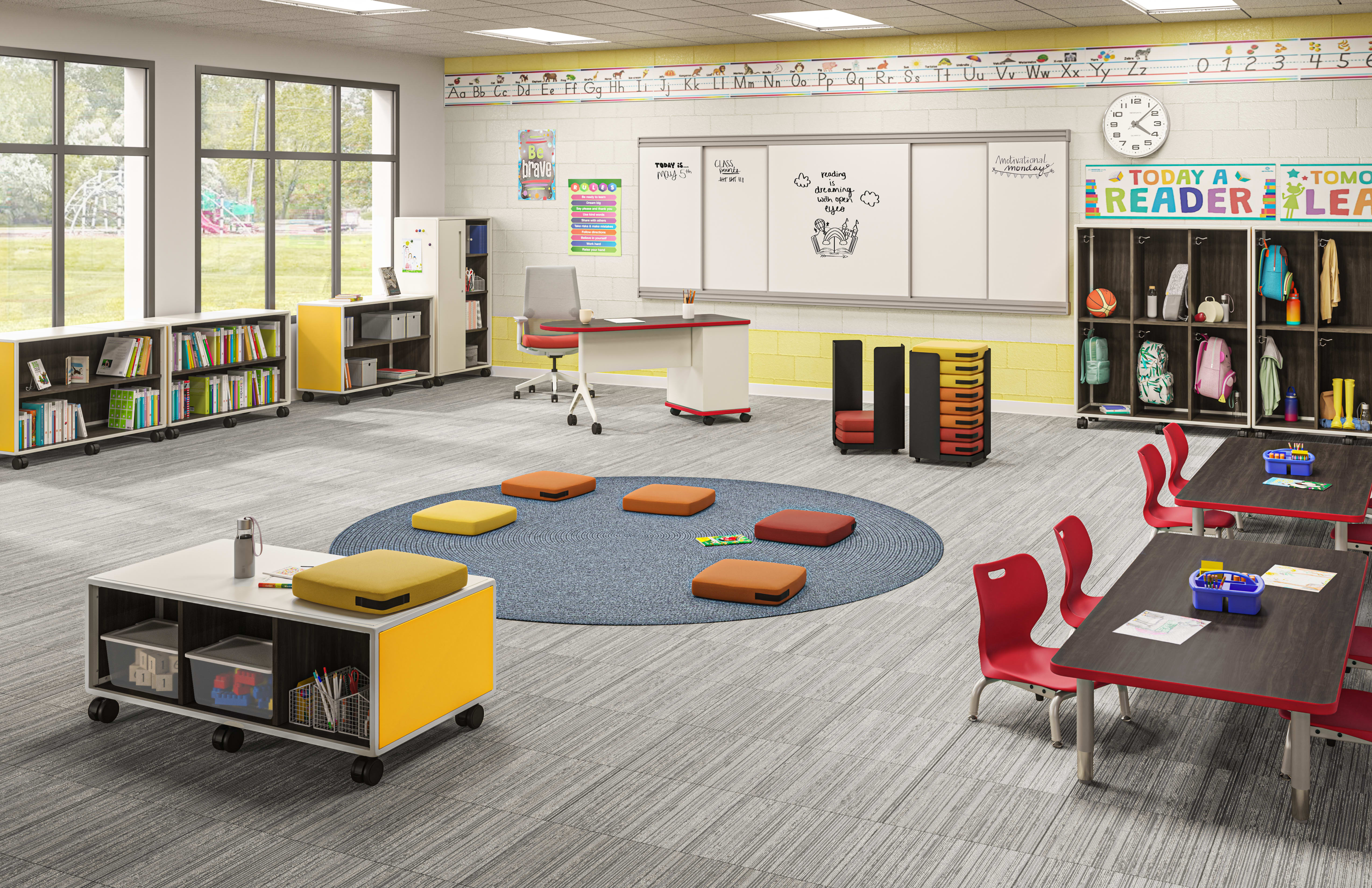 Bright elementary classroom with group seating, reading area, motivational displays, and organized storage.