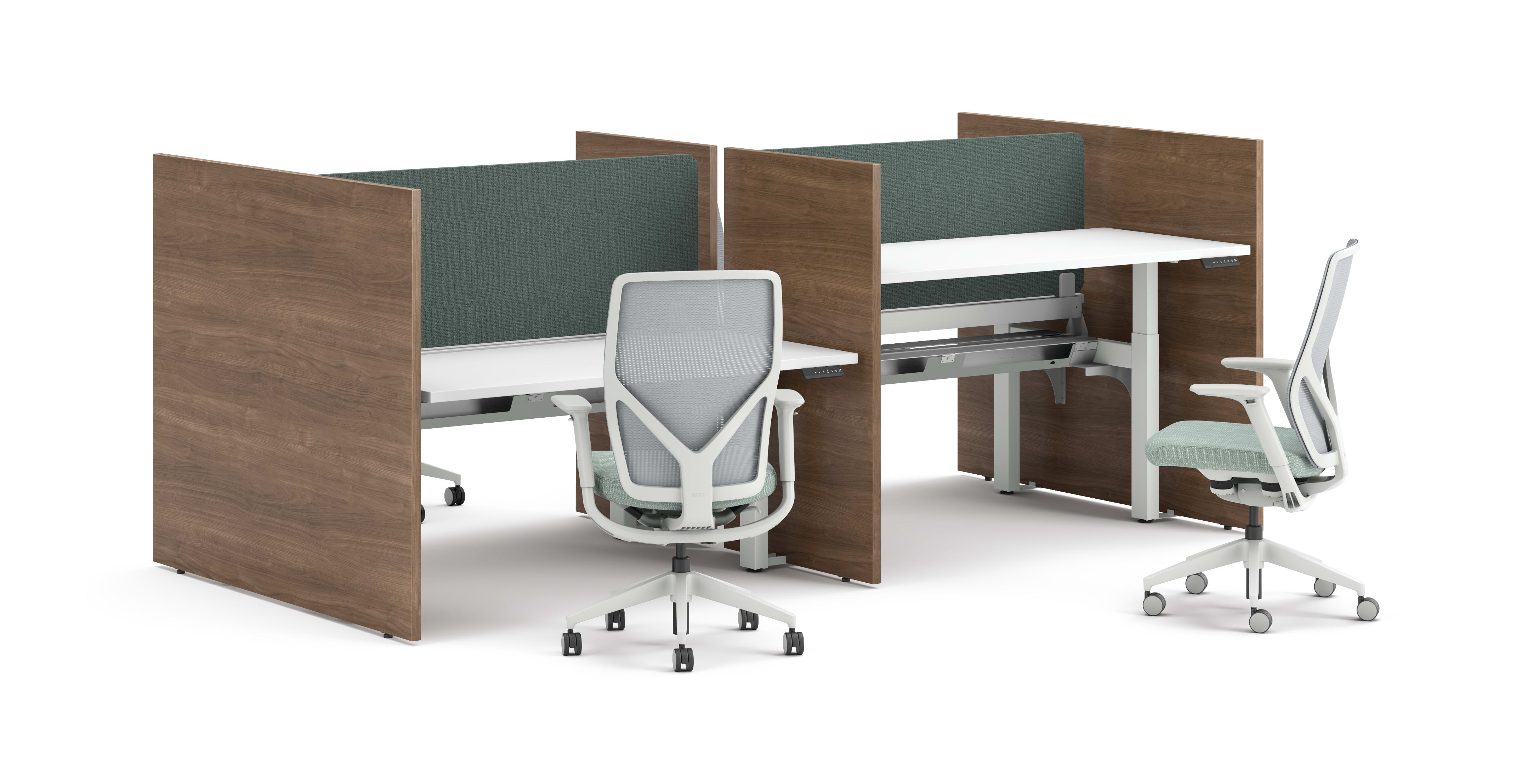 Two workstations with green fabric privacy panels, white desks, and ergonomic office chairs framed by wooden side panels.