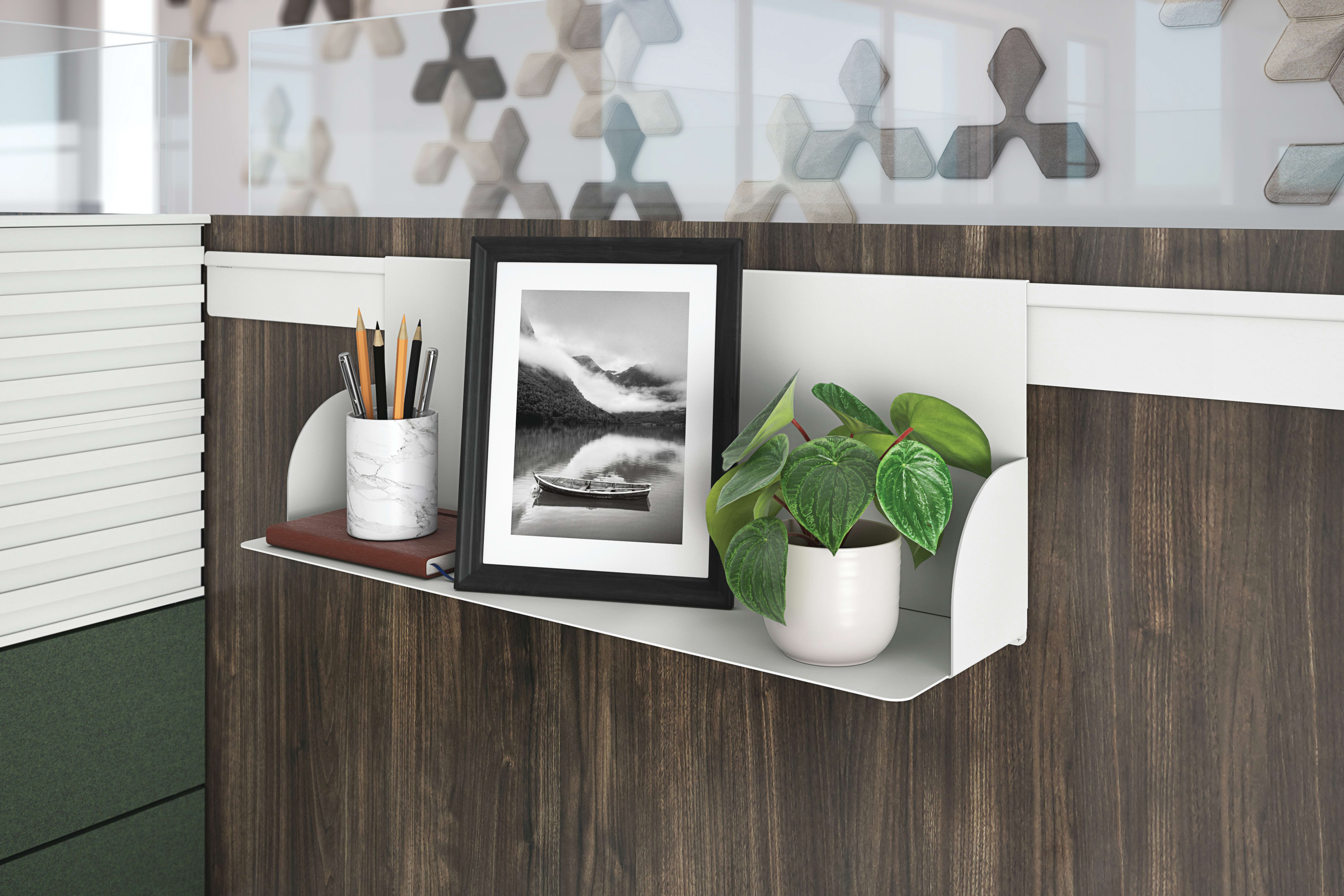 Gallery panel personal shelf holding pencil cup, picture frame and plant.