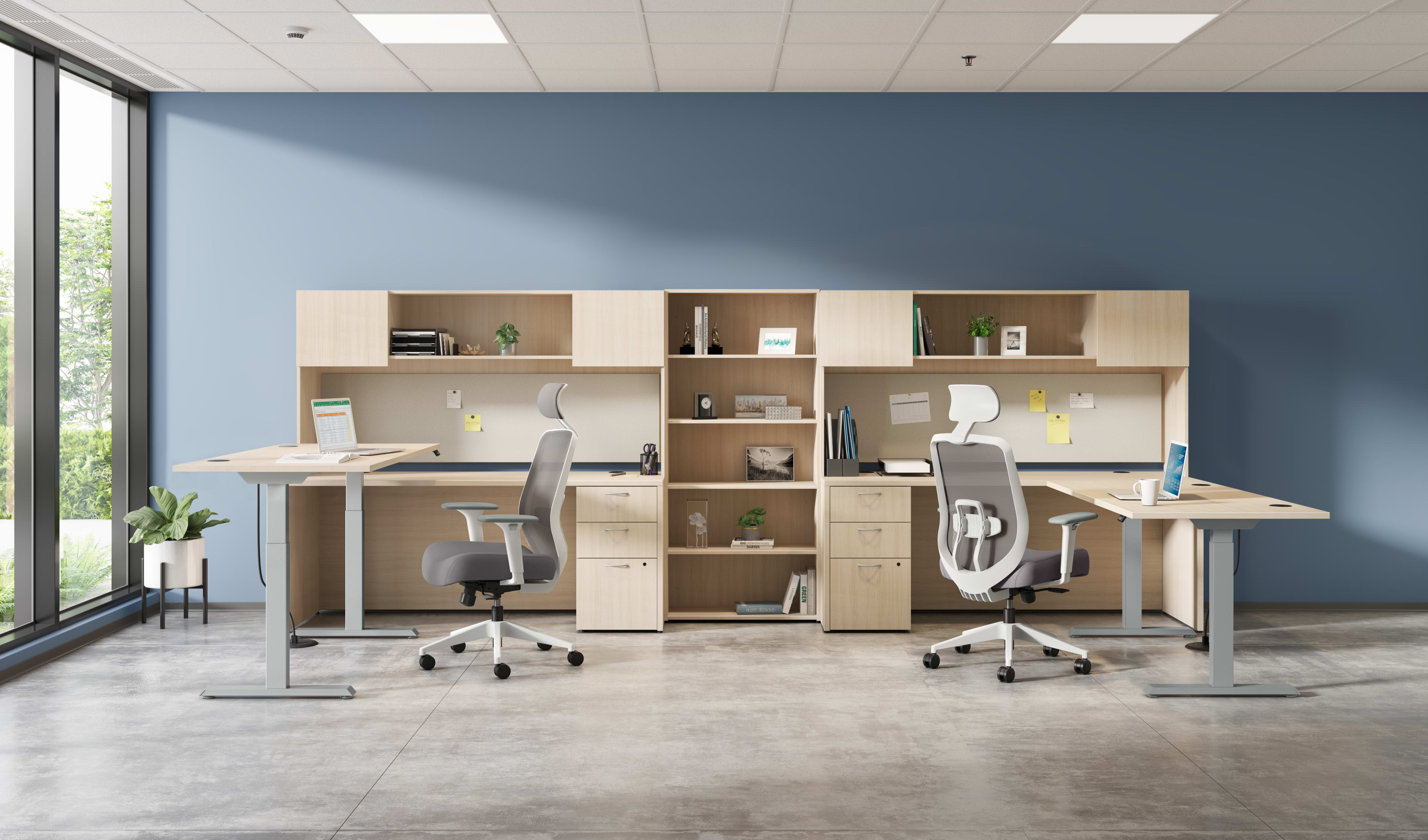 A modern and minimalist office space with desks, chairs, and shelving units arranged in a clean and organized manner, with large windows providing natural light.