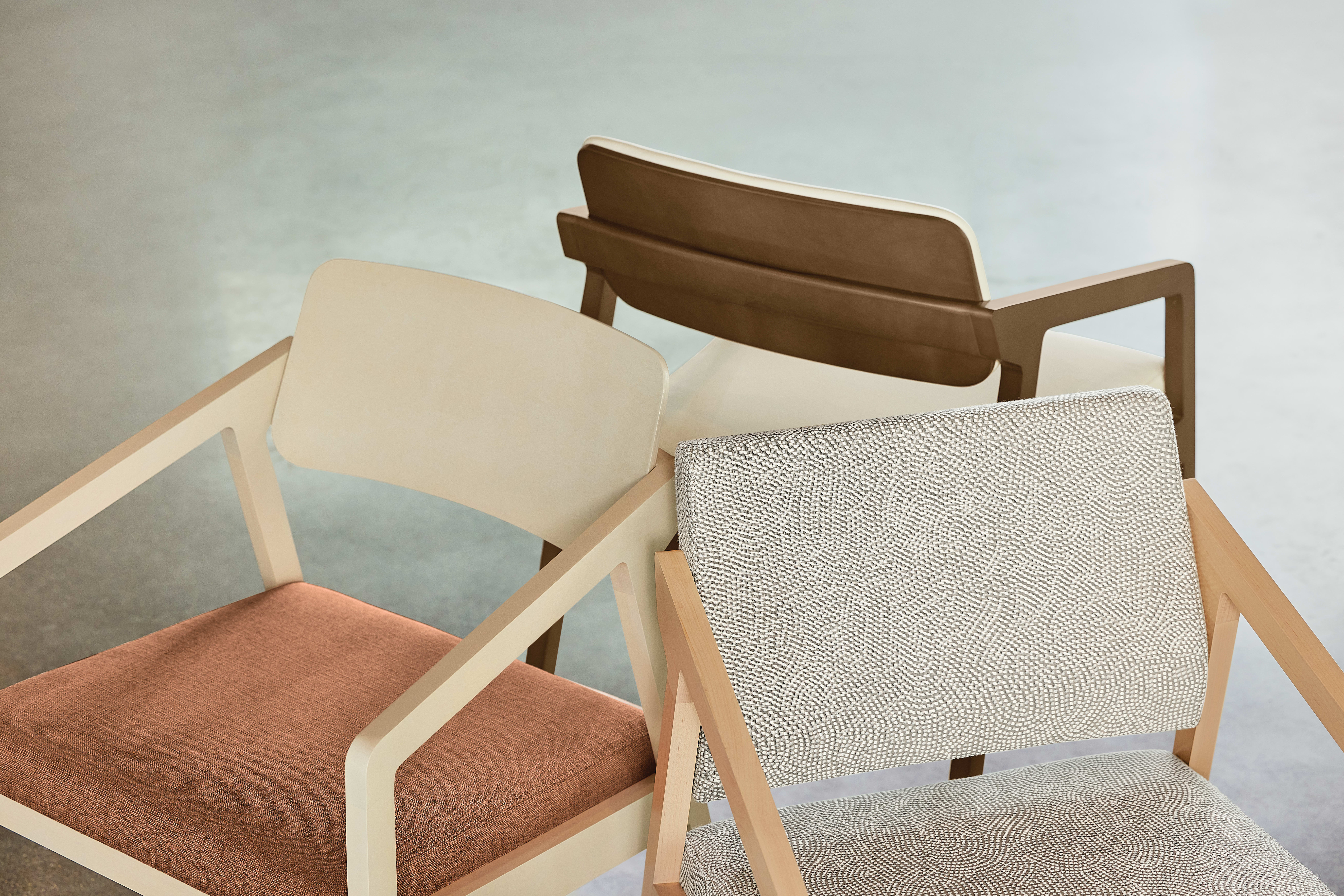 The image features a collection of modern, minimalist chairs in various shades of brown and beige, set against a neutral background.