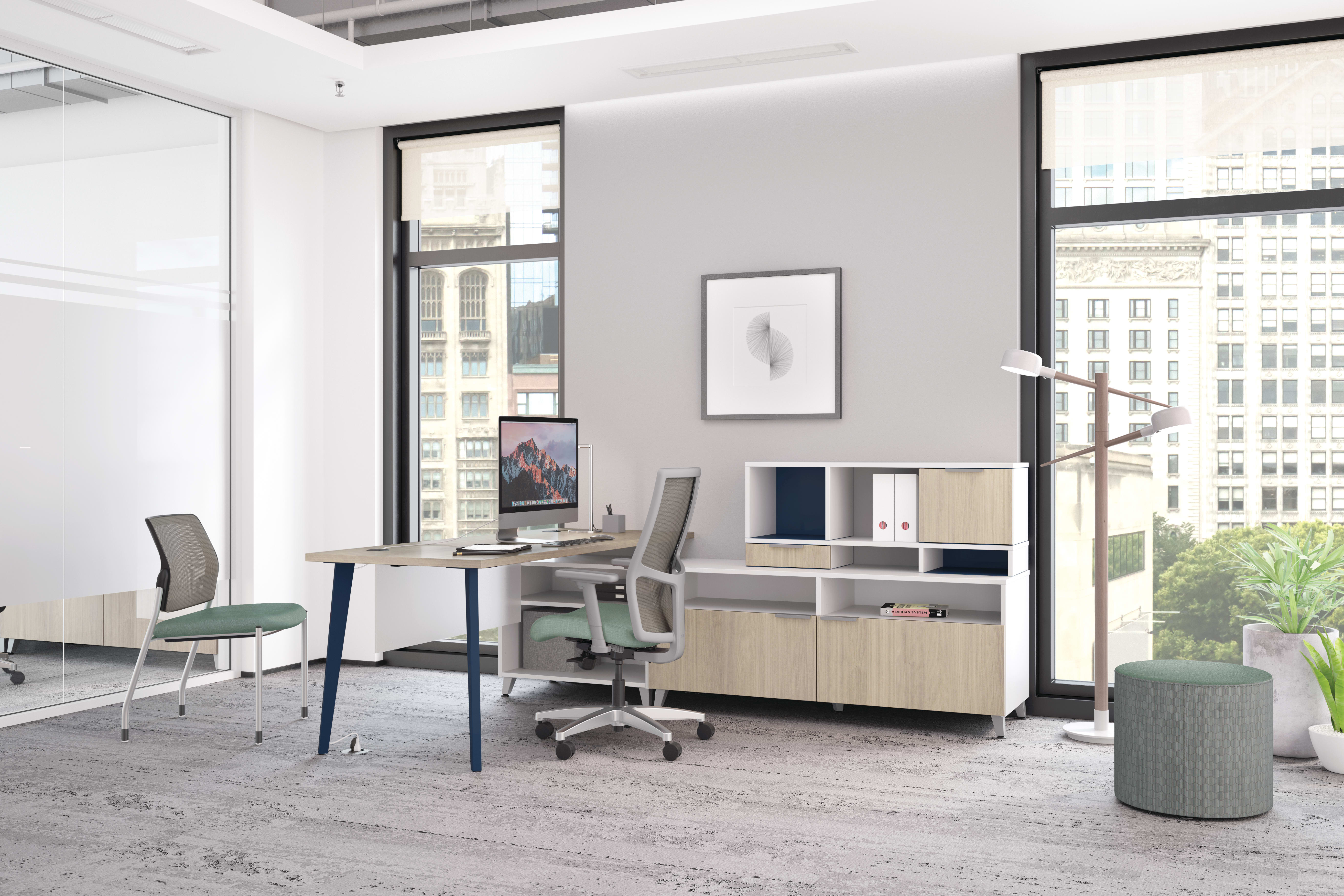 A modern and minimalist office space with a desk, chairs, and storage units, set against a backdrop of large windows overlooking a cityscape.