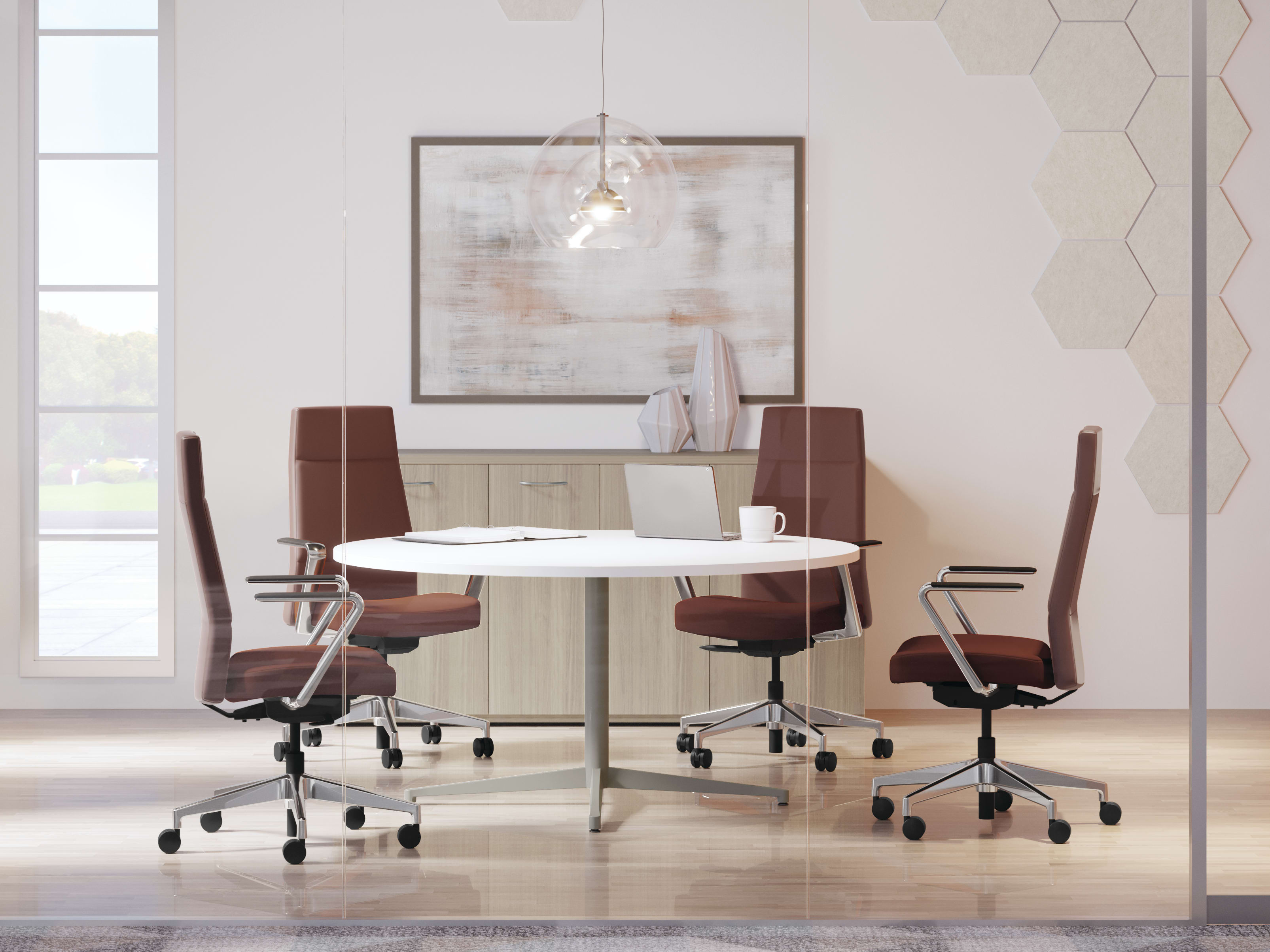 A modern, minimalist office space with a round white table, brown leather chairs, and a large framed artwork on the wall.