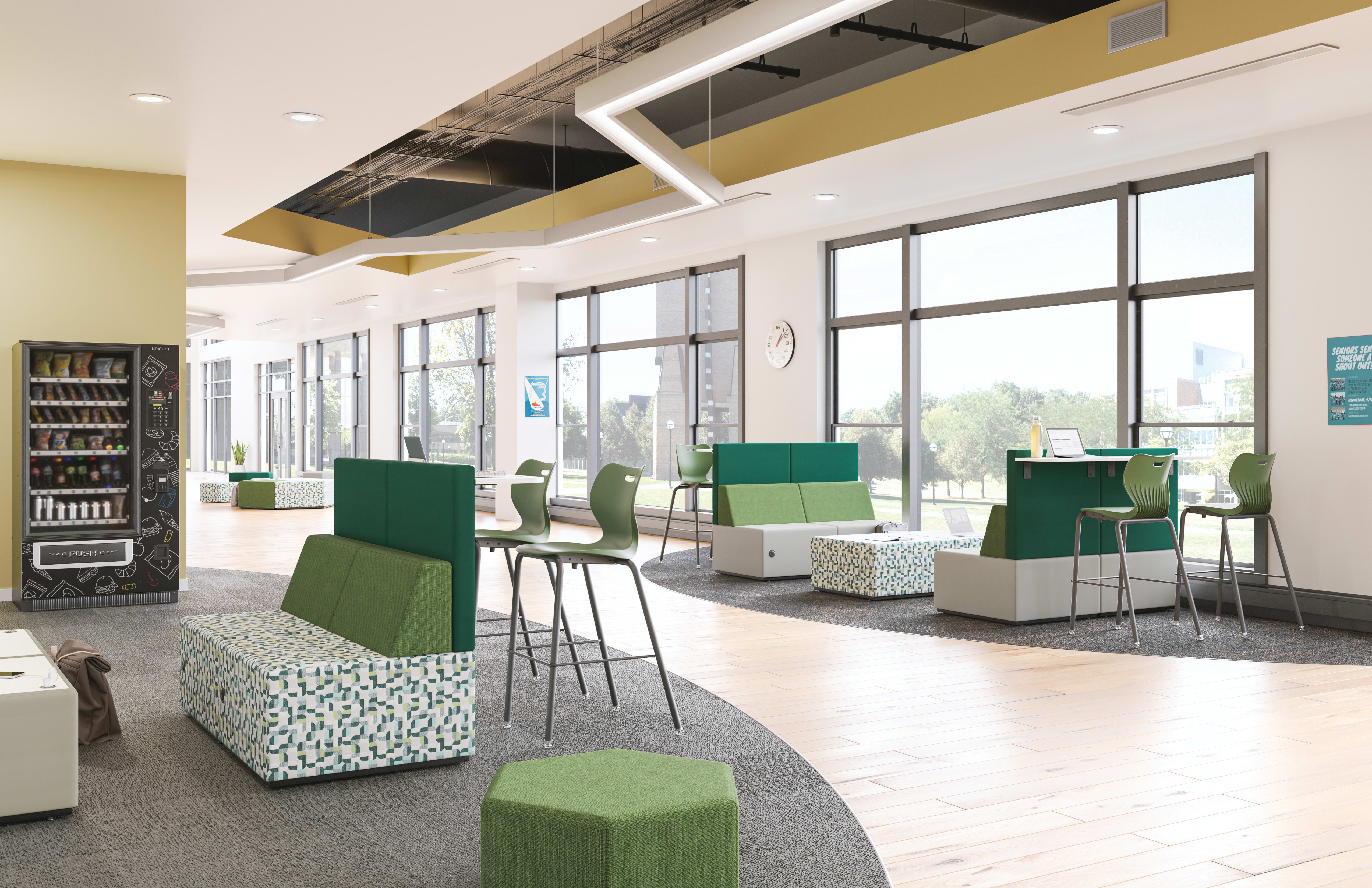 A modern, open-concept office space with green and white furniture, large windows, and a vending machine in the background.